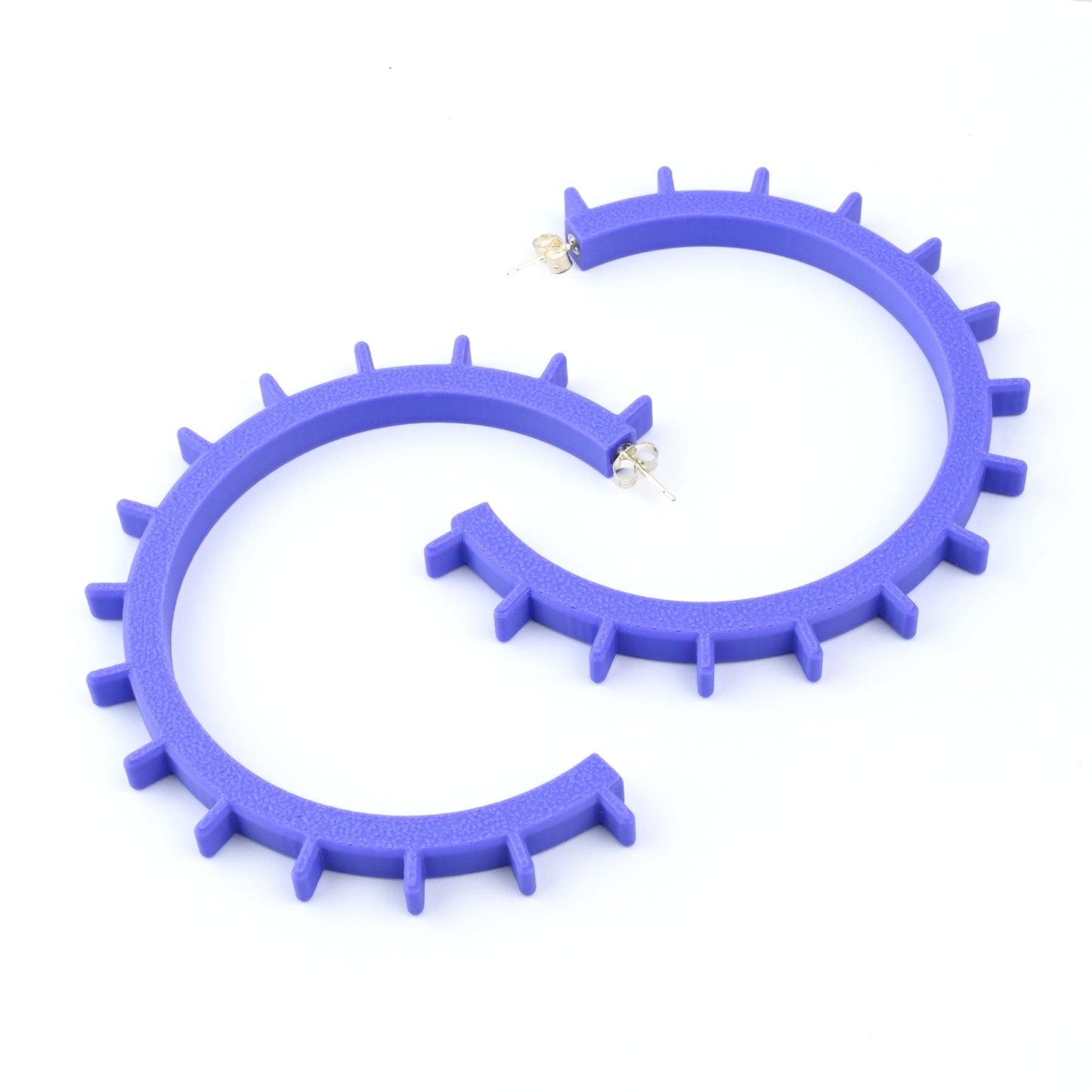 Pair of big purple cog shaped hoop earrings with silver ear posts on a white background