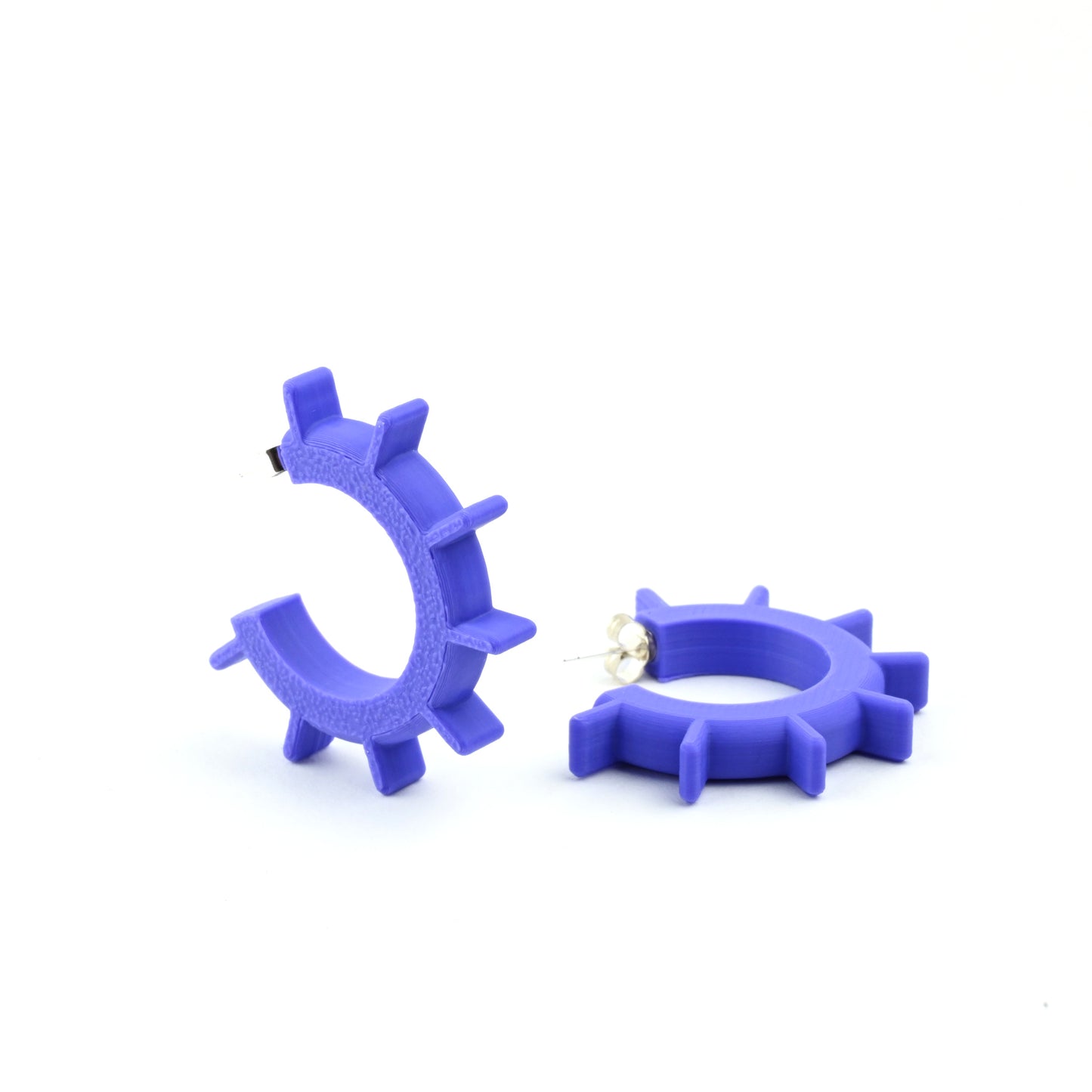 Purple hoop earrings with ridged design and silver ear posts on a white background