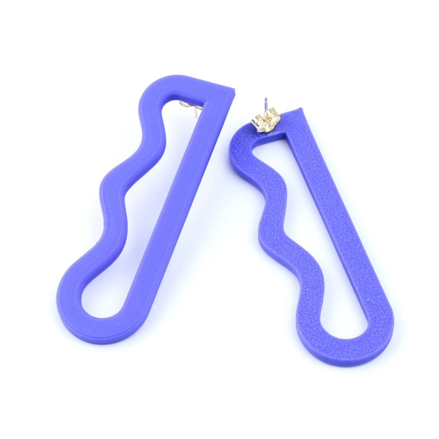 3D printed purple earrings with a wavy linear design by Roxwoods on a white background