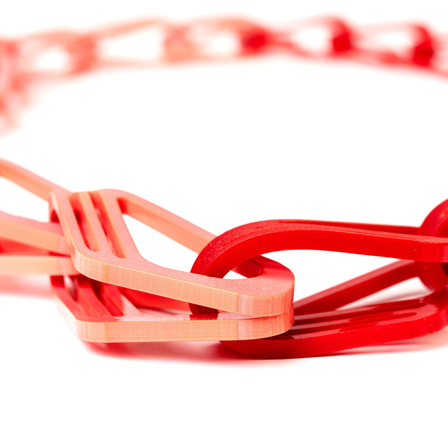 Halite Chain Necklace in Red & Pink with interlocking geometric acrylic links on a white background