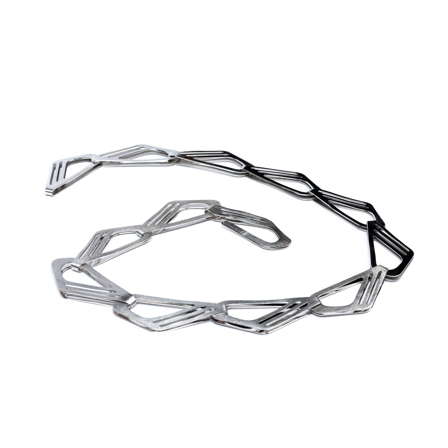 Geometric silver necklace on a white background
