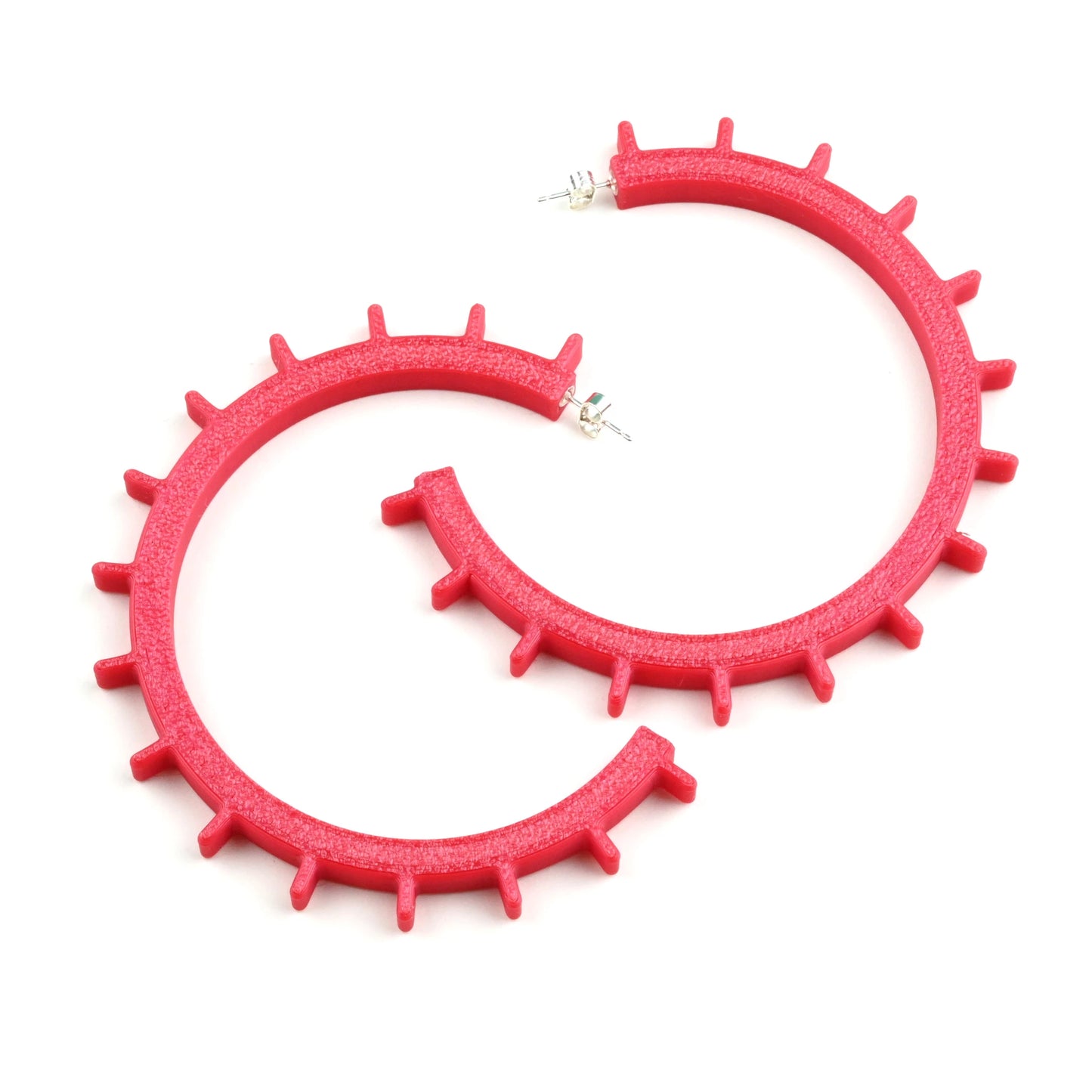The Axis Architectural Hoop Earrings - Large are bold, red geometric hoops featuring small, evenly spaced spikes along the outer edge—perfect statement earrings for a standout look. Displayed on a white background.