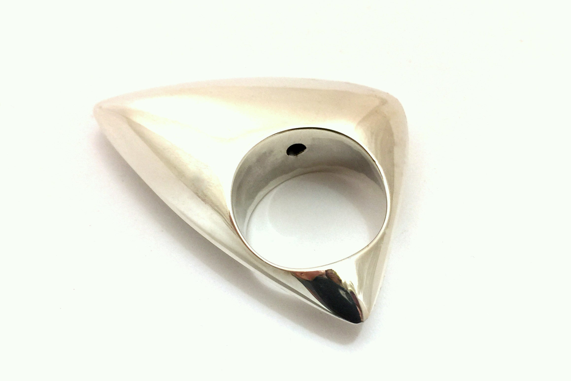 Large silver ring with domed and curved triangular shape.  The ring has a very shiny polished finish.