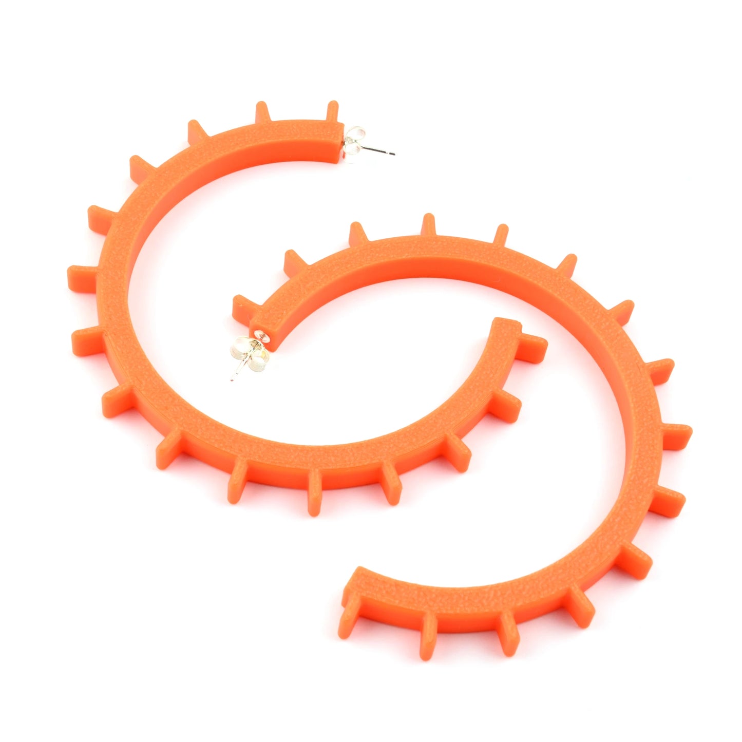 Pair of big orange cog shaped hoop earrings with silver ear posts on a white background