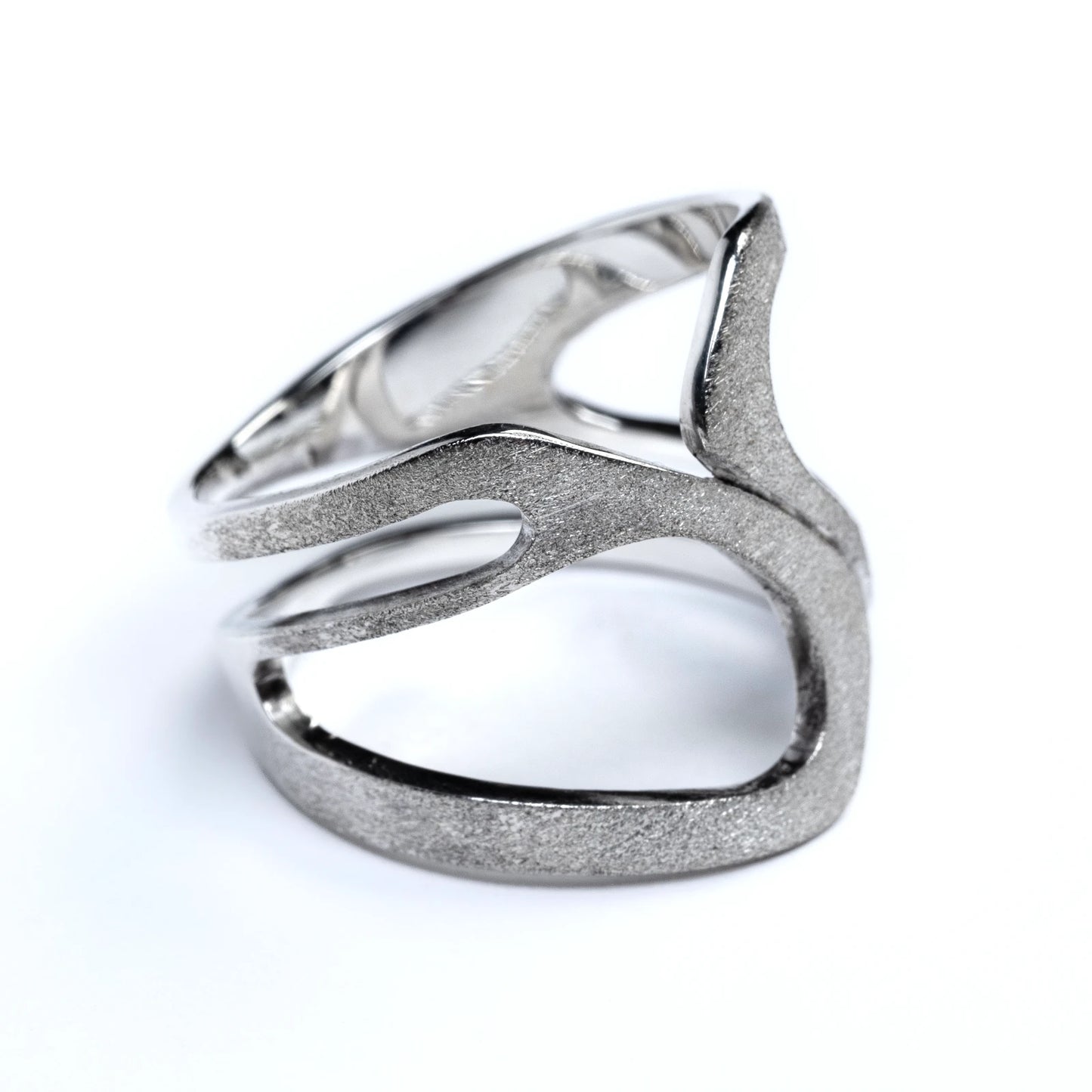 Silver ring with a unique design on a white background
