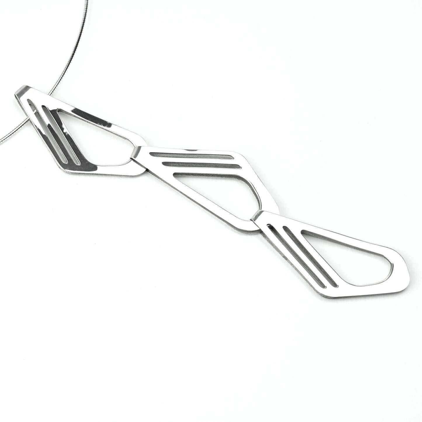 Silver pendant necklace detail on a white background