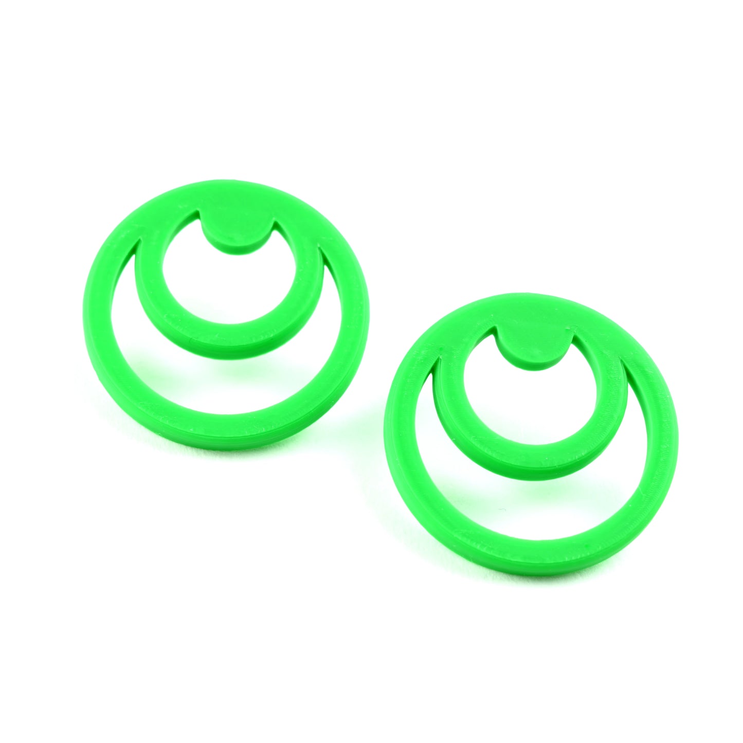 Two green circle earrings on a white background