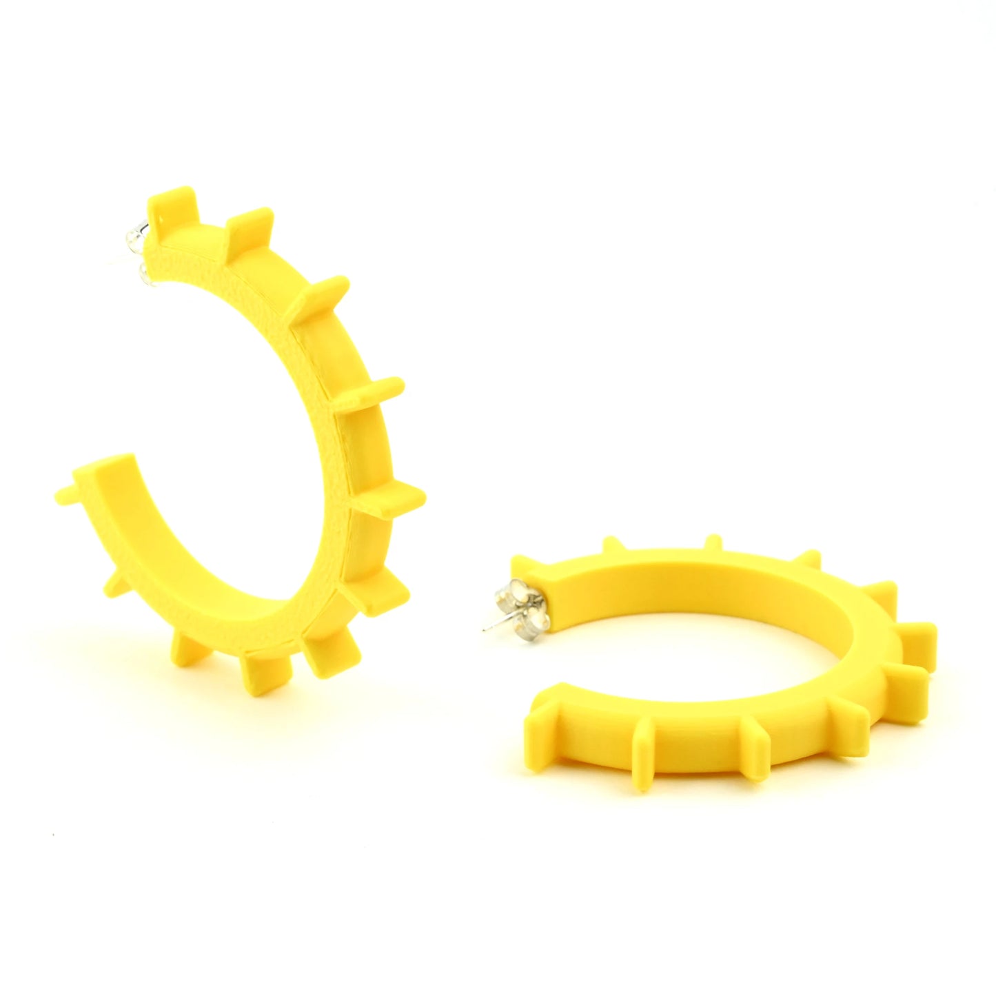 Medium sized yellow hoop earings with spikes and silver ear posts on a white background