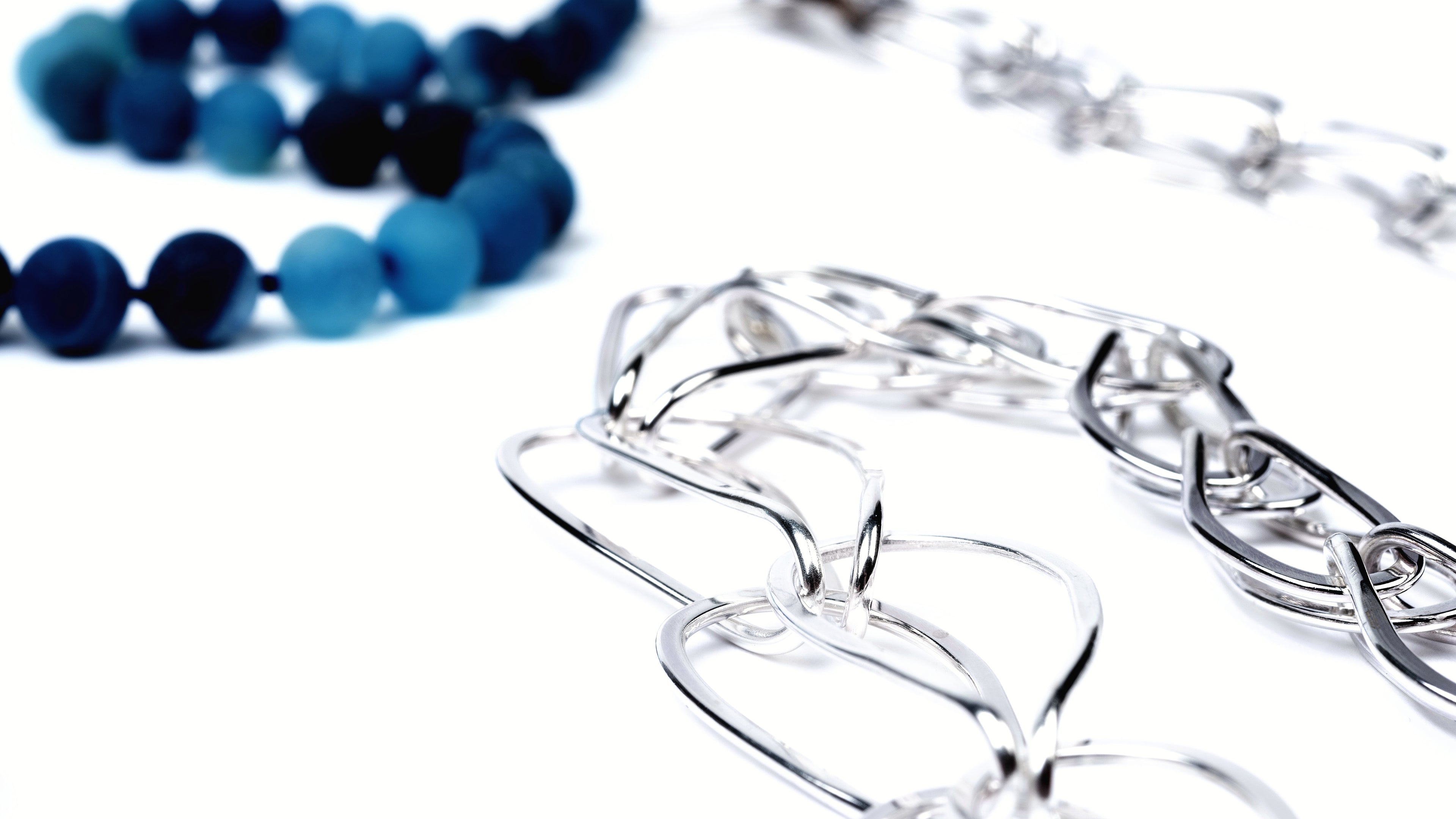 Large silver linked chain with hand knotted blue druzy beads in various tones of blue.  The chain is very shiny