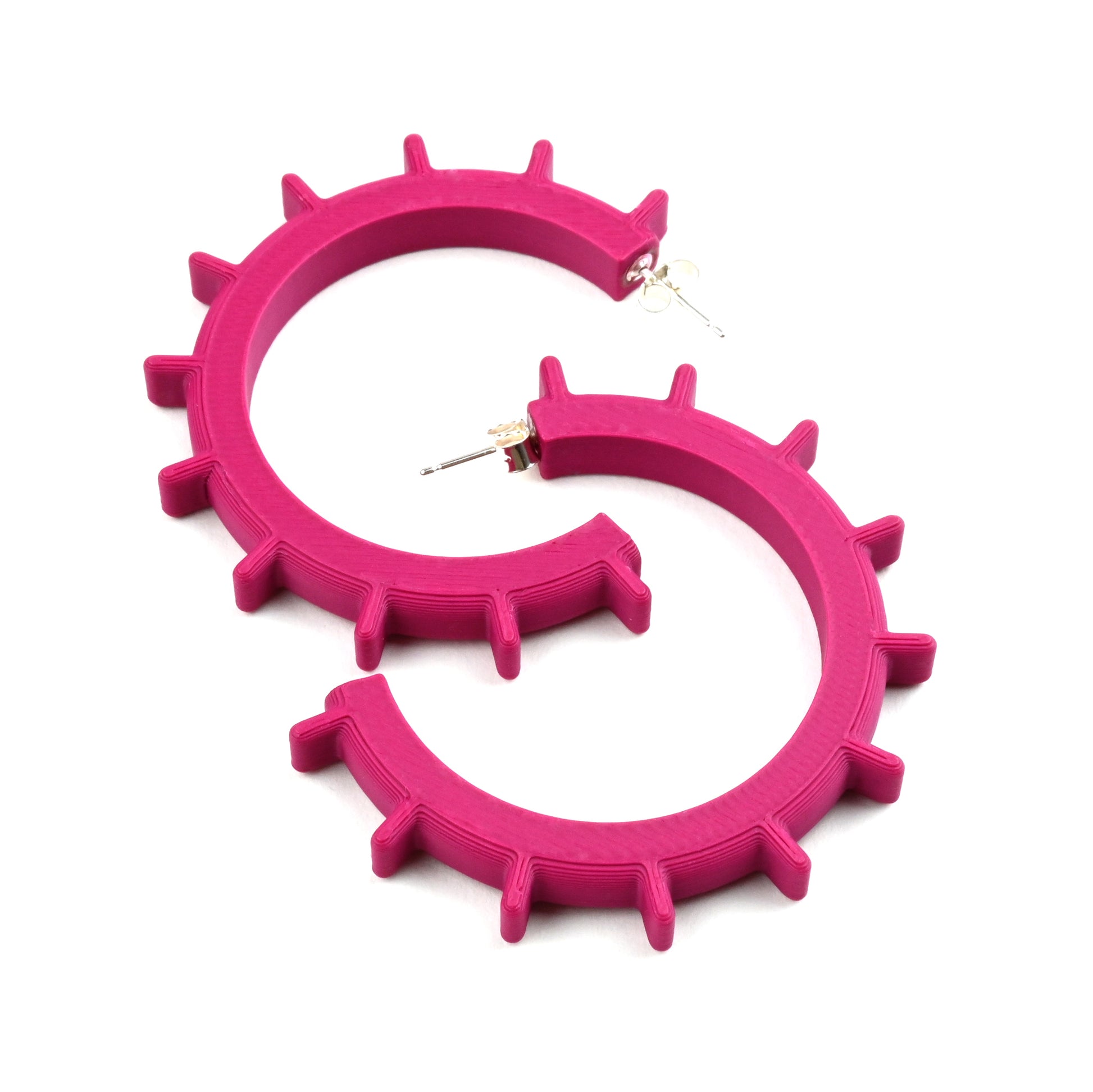 Plum coloured large hoop earrings with silver ear posts and silver earring backs.  The hoops have ridges sticking out along the outside edge of the hoops.  The earrings are made of 3D printed plastic in a medium size.