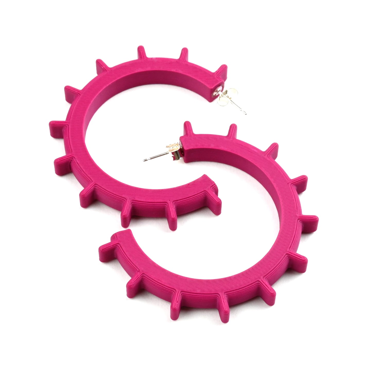 Plum coloured large hoop earrings with spikes and silver ear posts on a white background  
