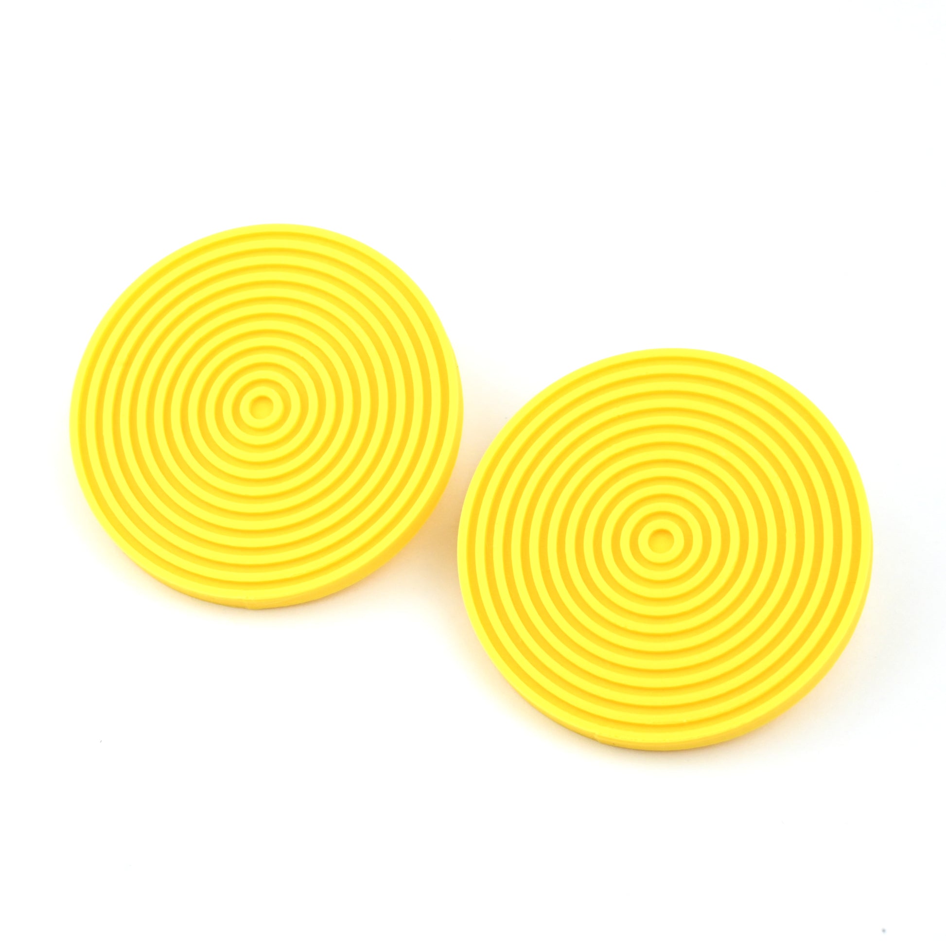 Pair of round yellow earrings with concentric circle design on a white background.