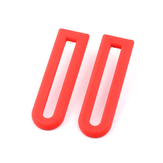 Two red U-shaped drop earrings on a white background