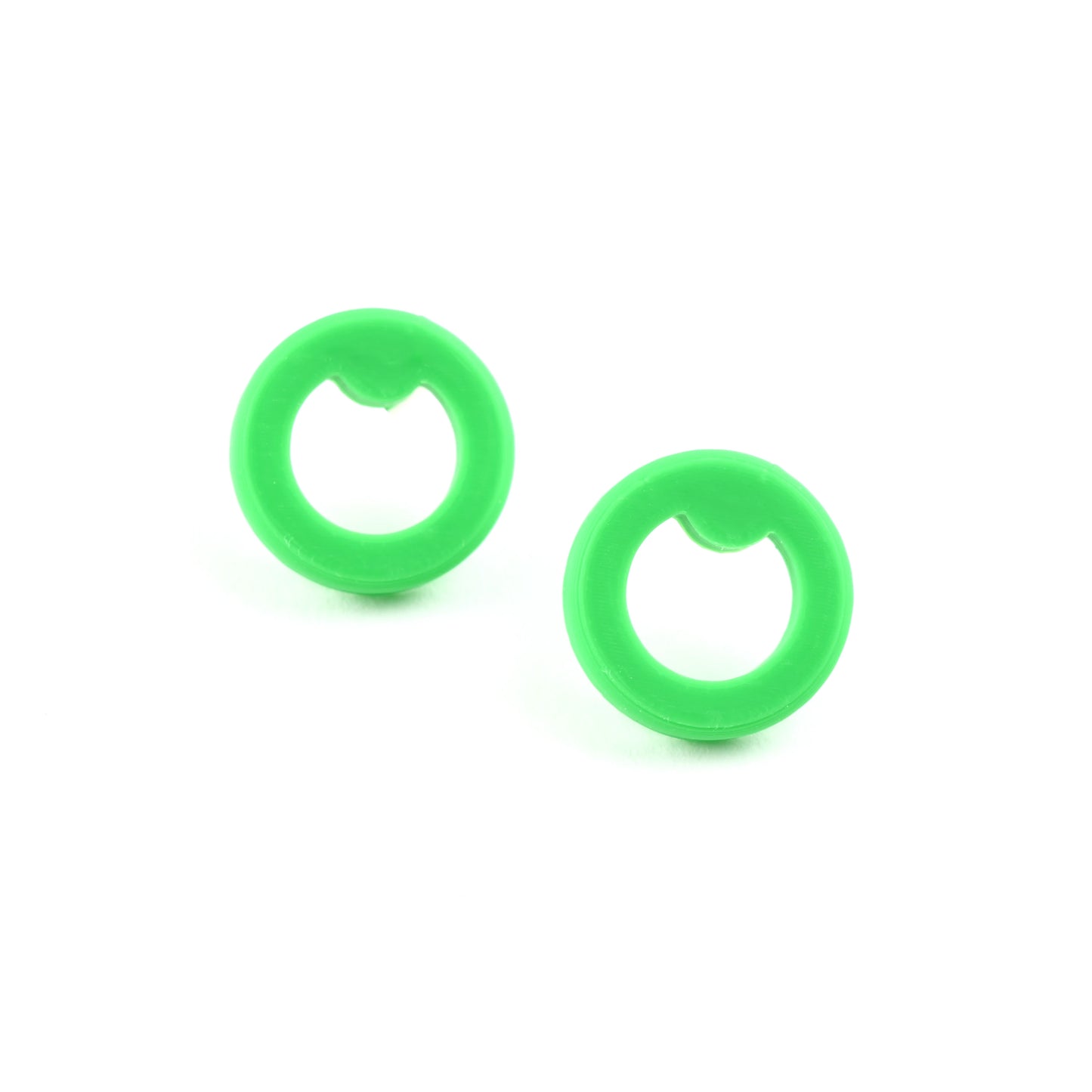 Pair of small green circle stud earrings on a white background
