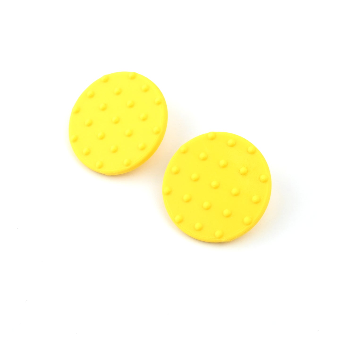 A pair of yellow round disk earrings with raised dot pattern on a white background