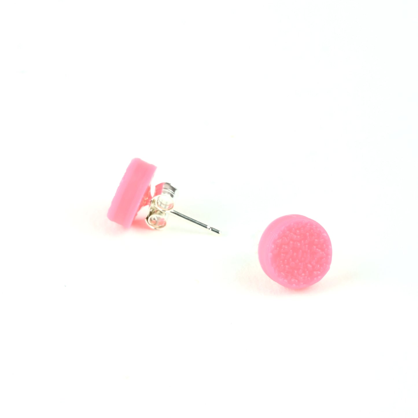 Pink textured tiny round stud earrings on a white background