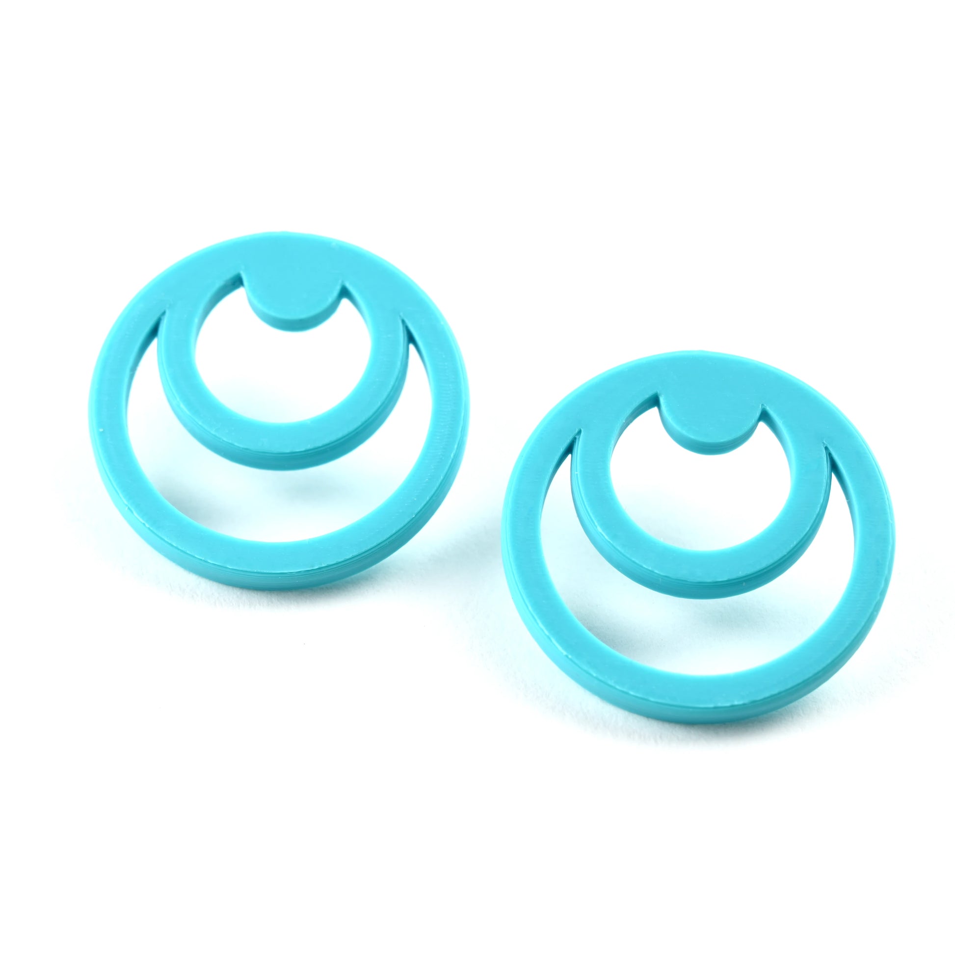 Pair of turquoise twin round earrings on a white background