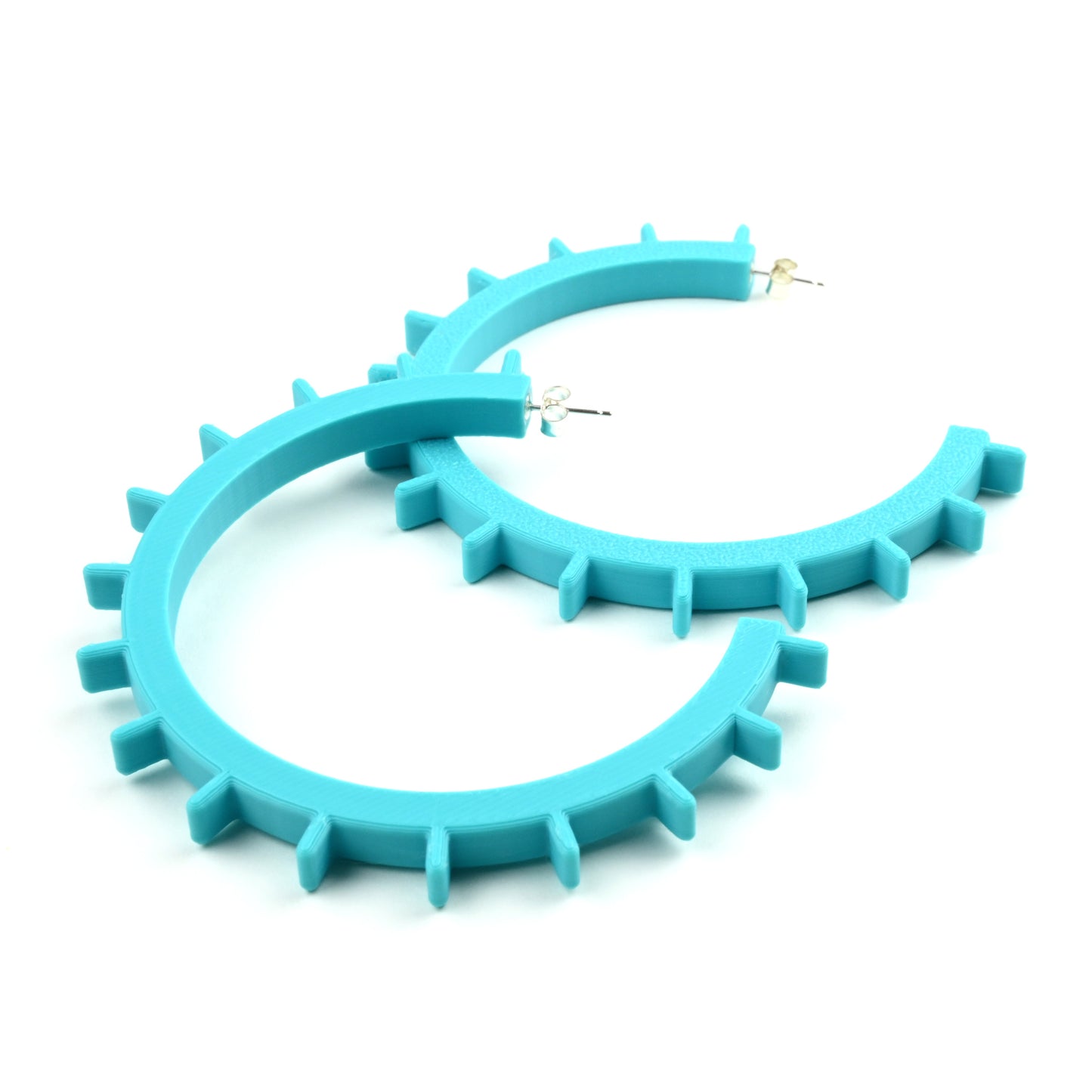 Turquoise hoop earrings with spike details on a white background