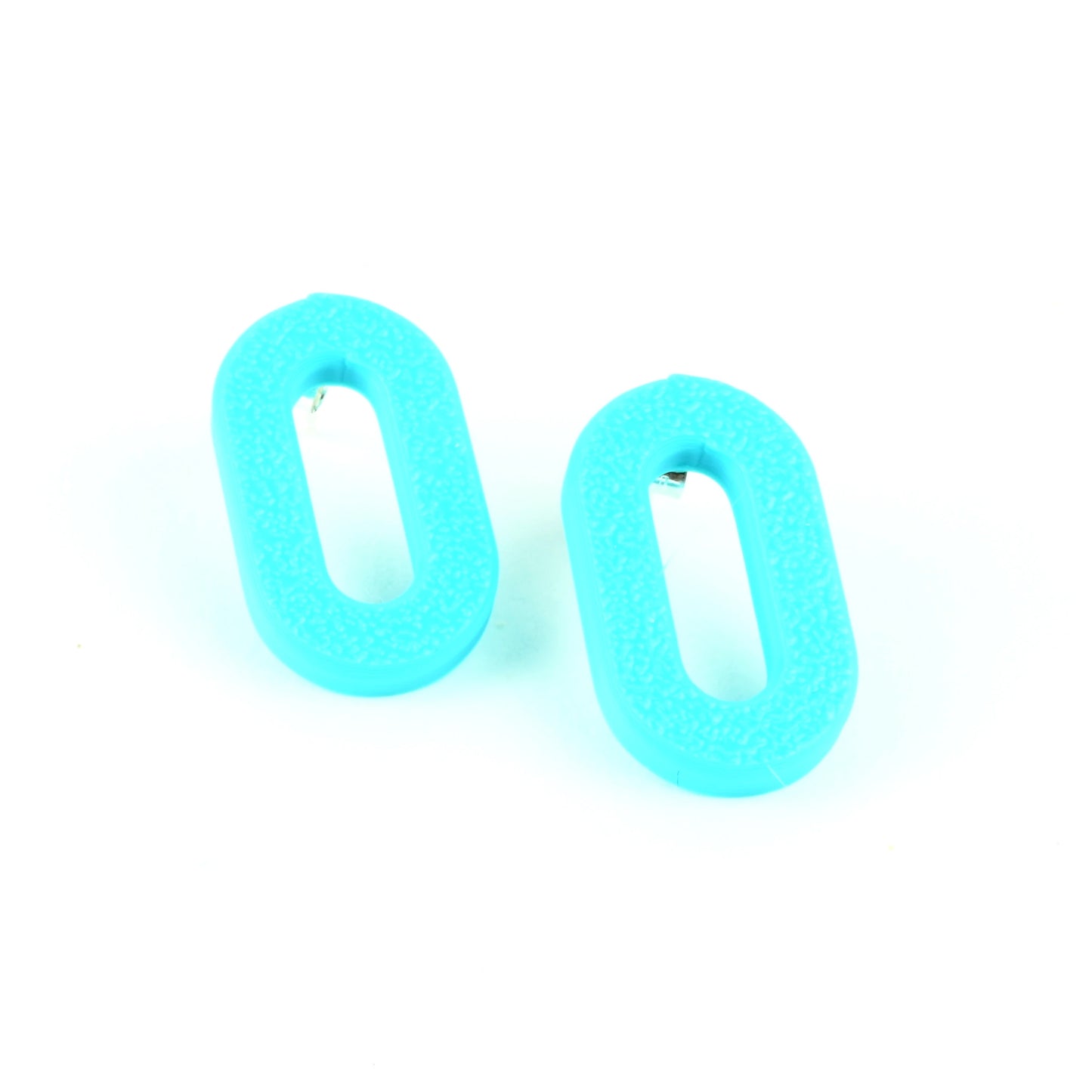 Pair of turquoise oval earrings with a textured surface on a white background