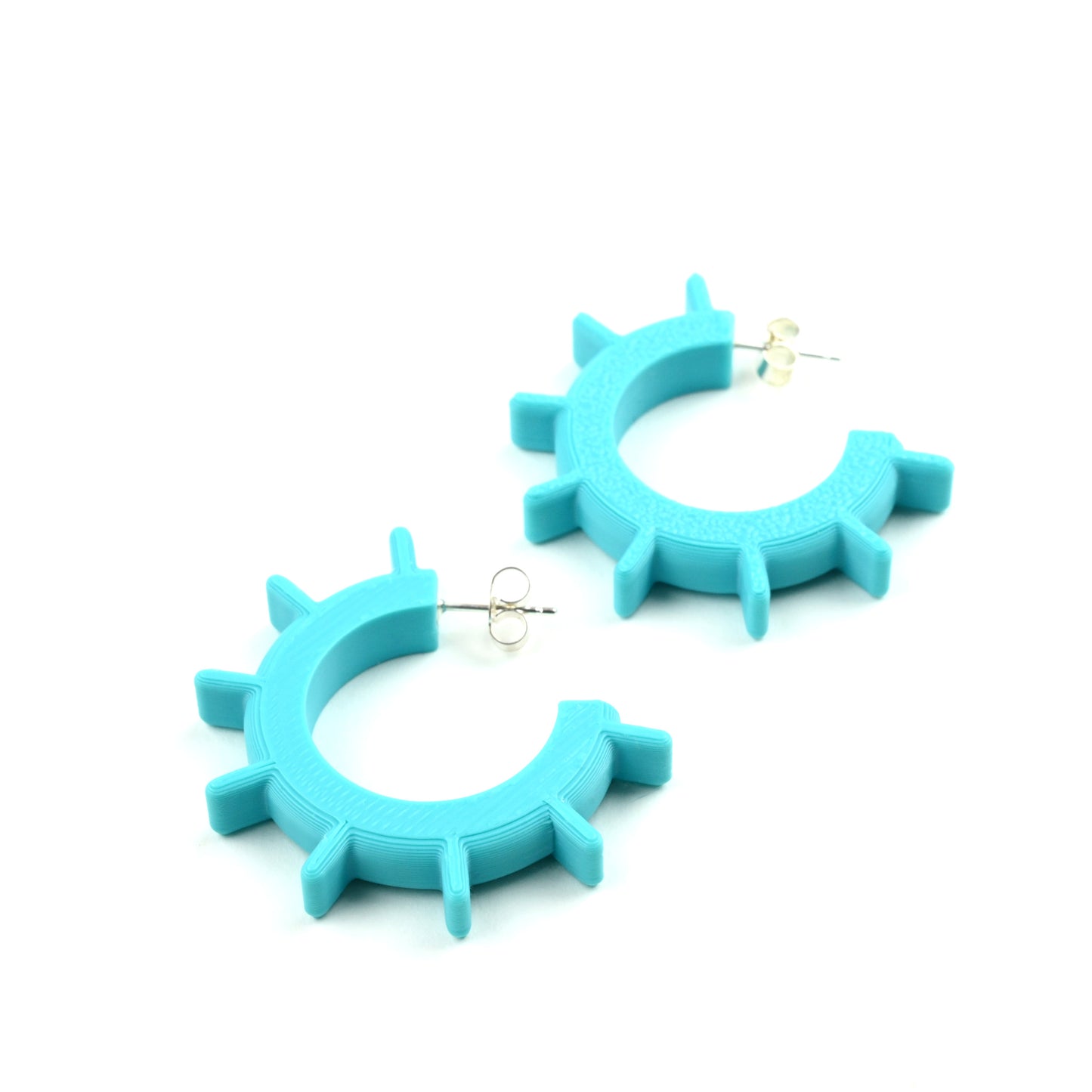 Pair of turquoise hoop earrings on a white background