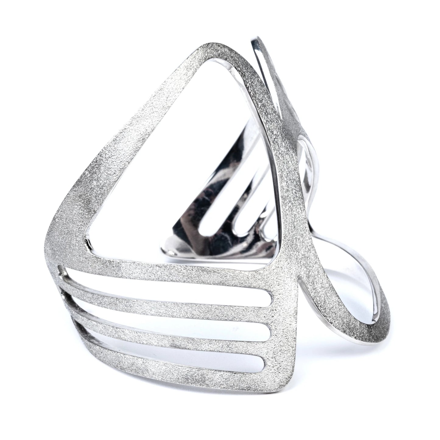 Wide sterling silver cuff with a geometric design and frosted texture on a white background