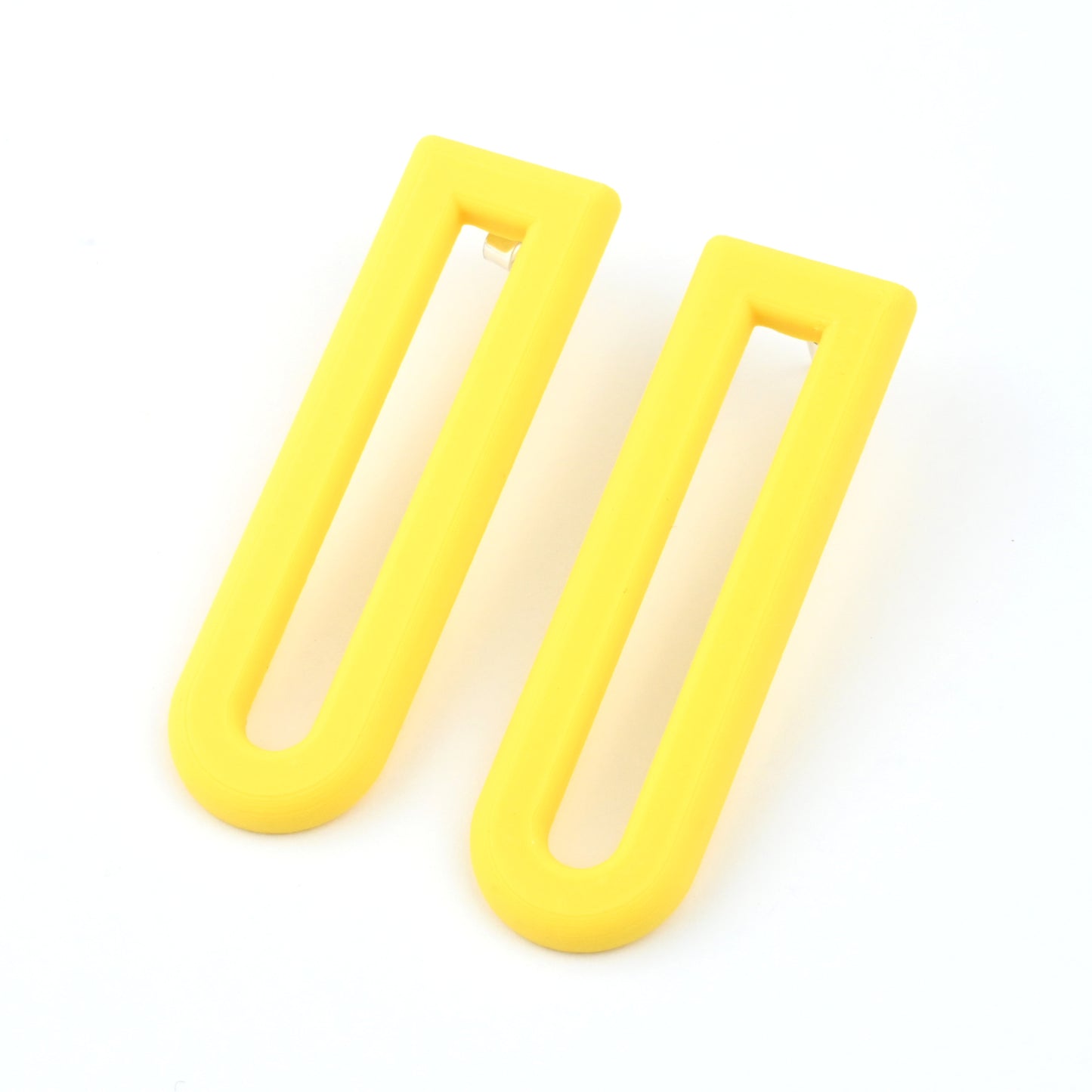 Pair of yellow U shaped drop earrings with silver ear posts on a white background