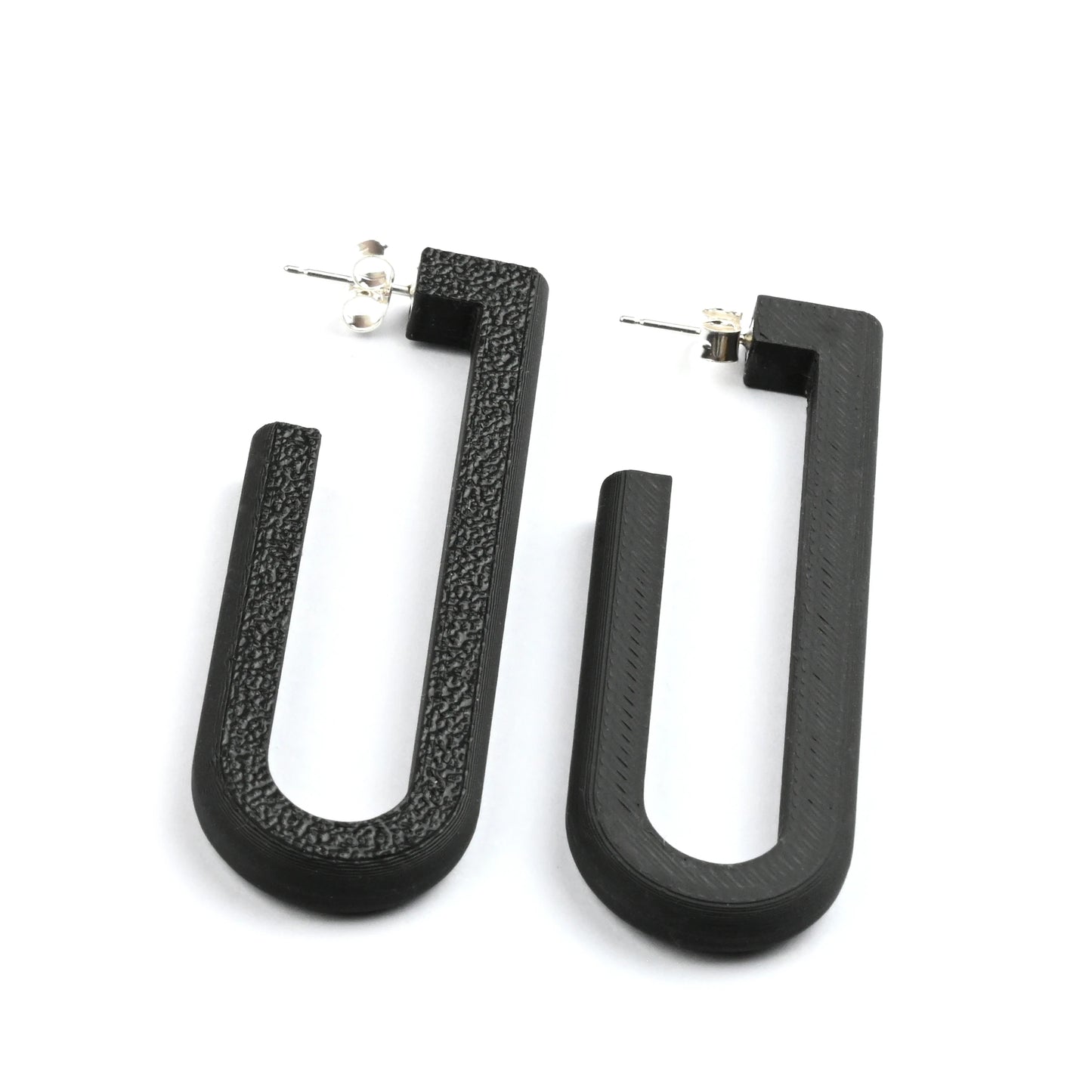 Black U-shaped hoop earrings on a white background