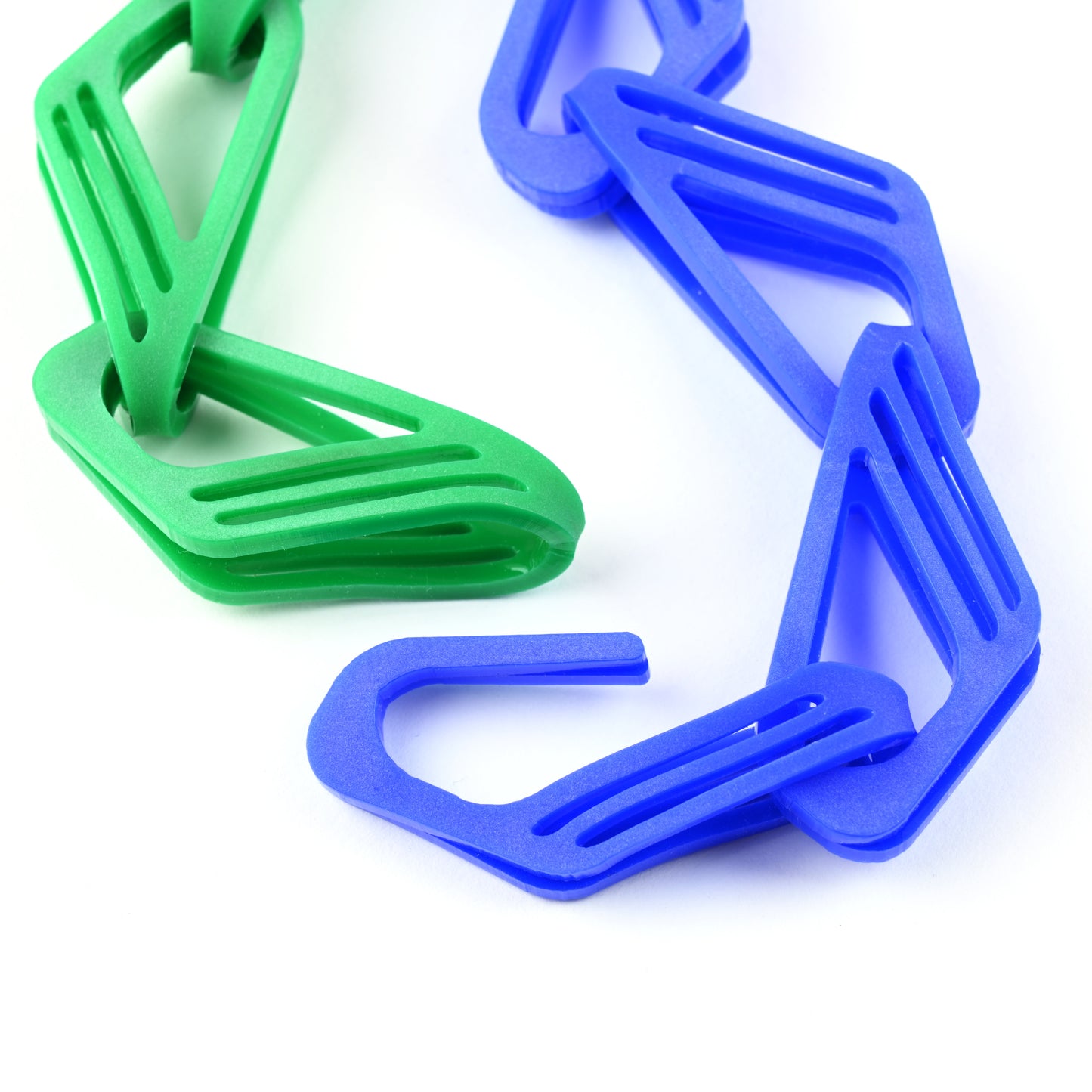 Green and blue plastic links on a white background