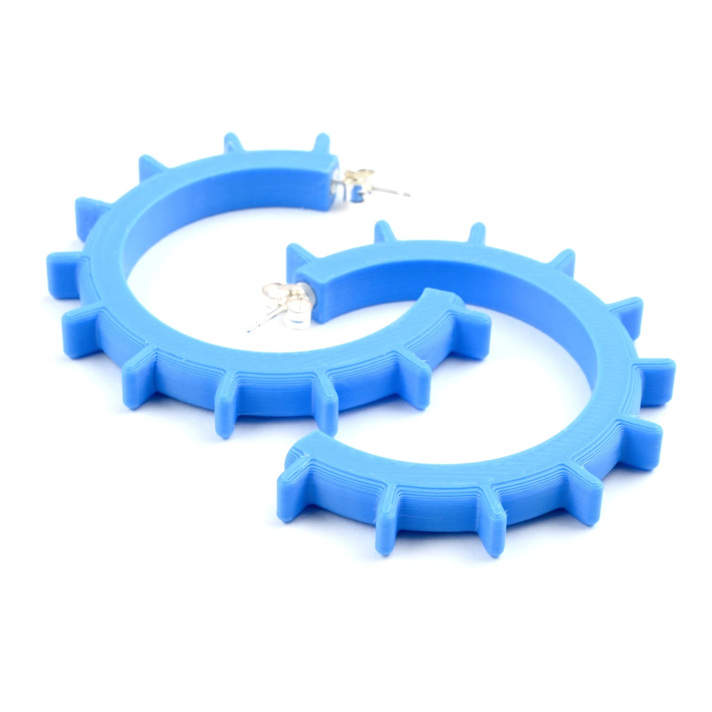 Cyan blue medium sized geometric hoop earrings with silver ear posts on a white background.