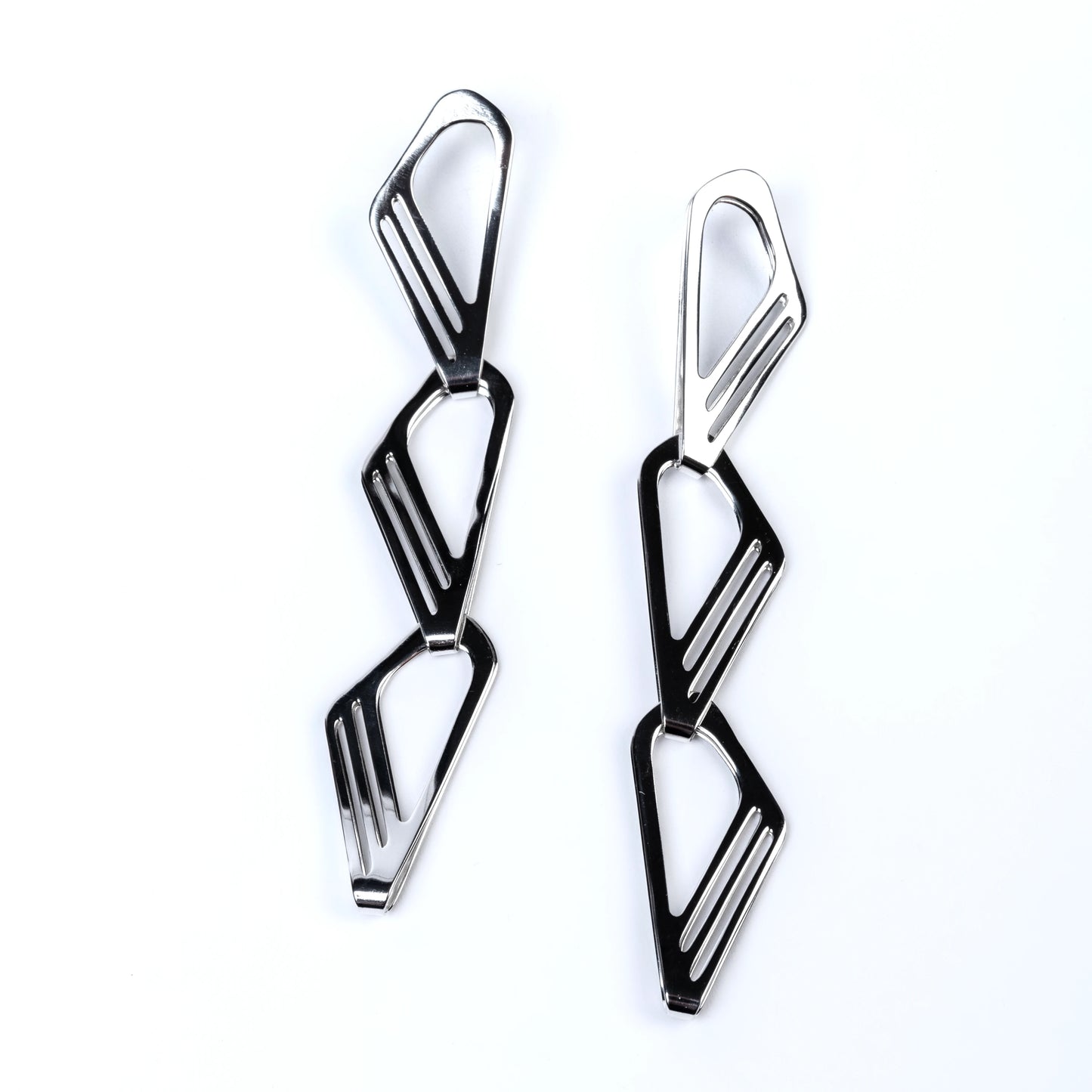 Pair of geometric silver earrings on a white background