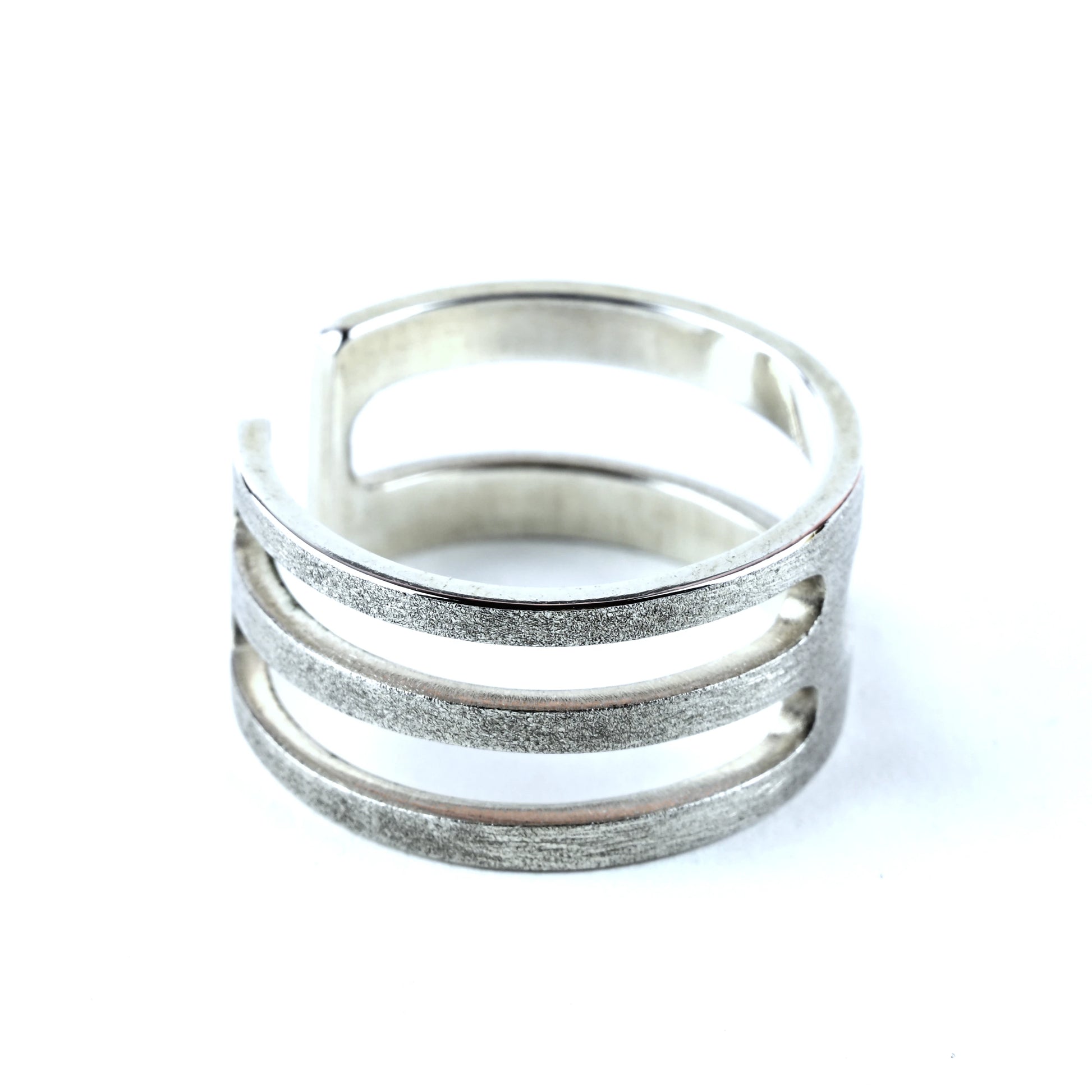 Silver ring with multiple bands on a white background