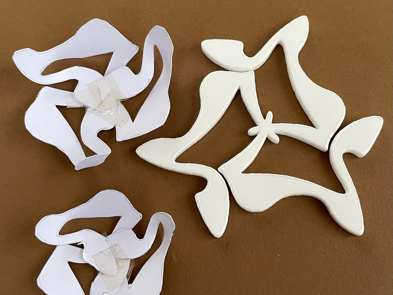 Cut out paper shapes stuck together with tape to create three dimensional forms. 