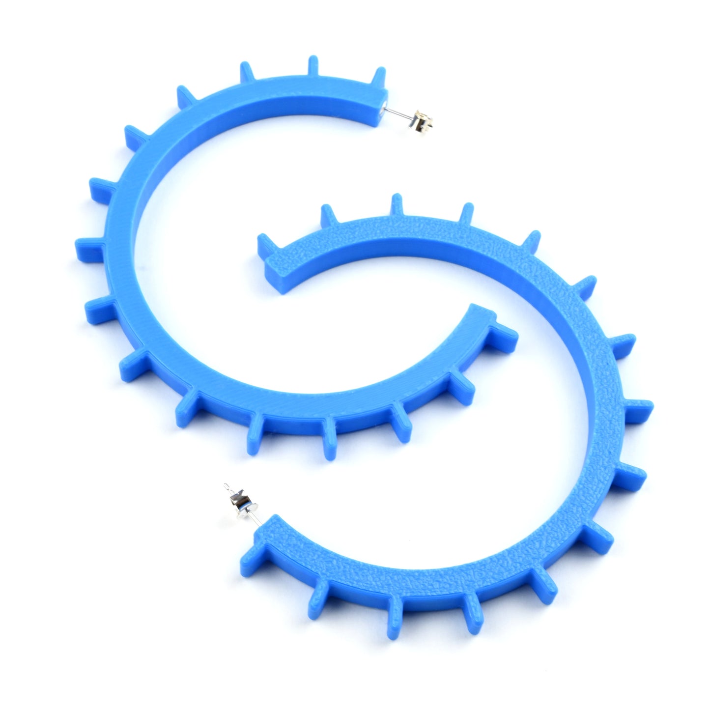 Cyan blue plastic hoop earrings with silver ear posts and silver earring scroll backs.  The earrings have a lightly textured side and ridges along the front edge of the hoops.