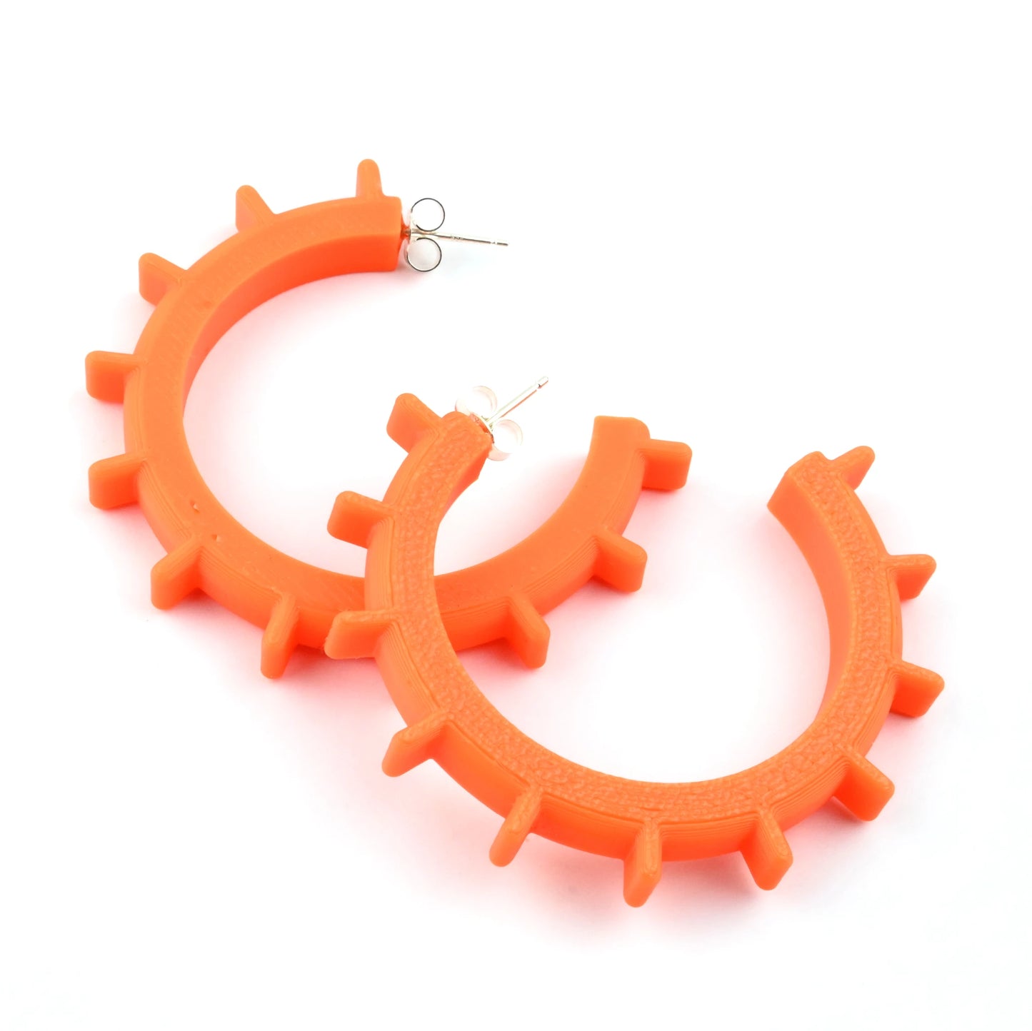 3 pairs of hoop earrings in different sizes with a circular shape & ridge design on a white backdrop