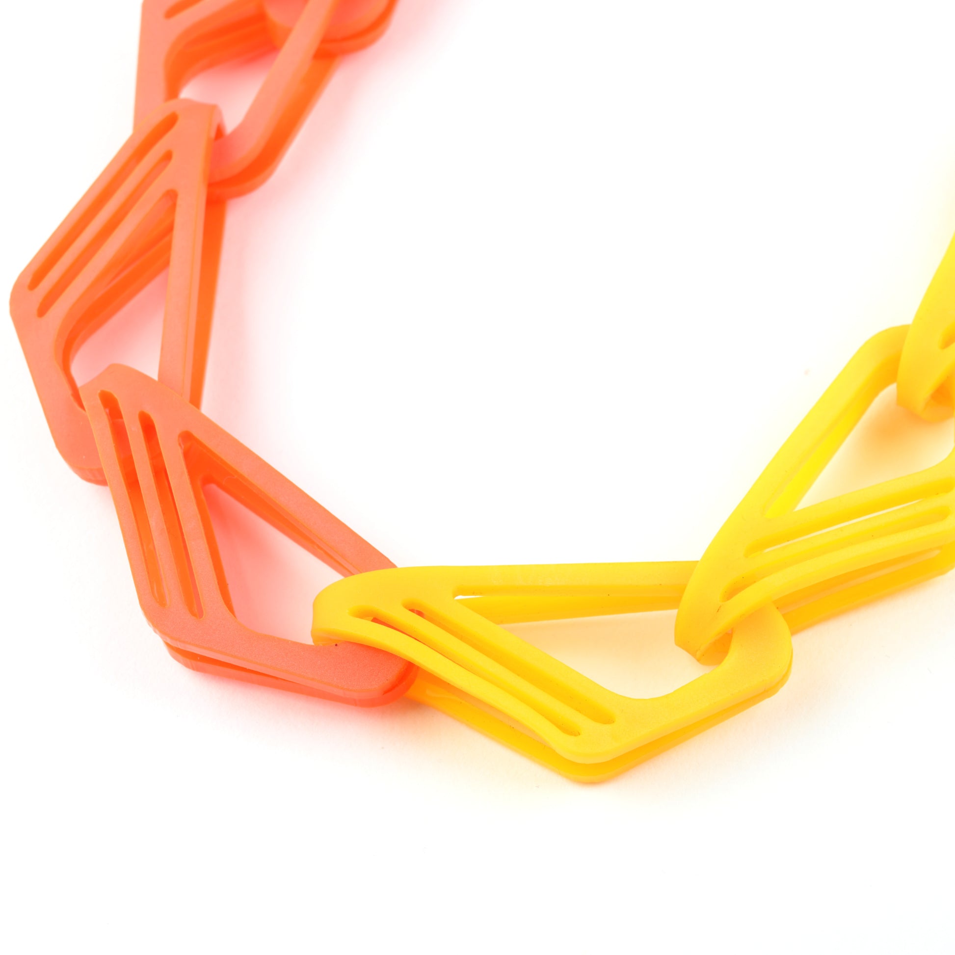 Necklace with orange and yellow geometric links on a white background