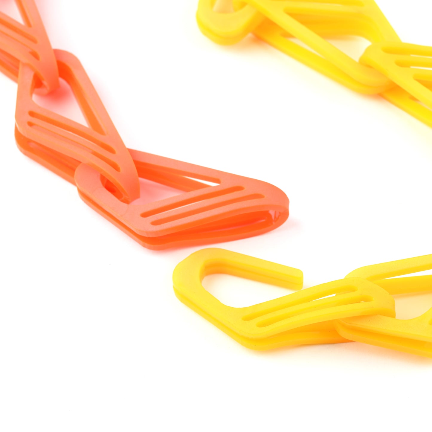 Necklace with orange and yellow geometric links on a white background
