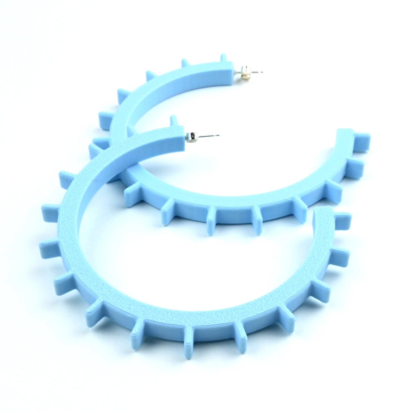 Pale blue 3D printed hoop earrings with geometric design on a white background