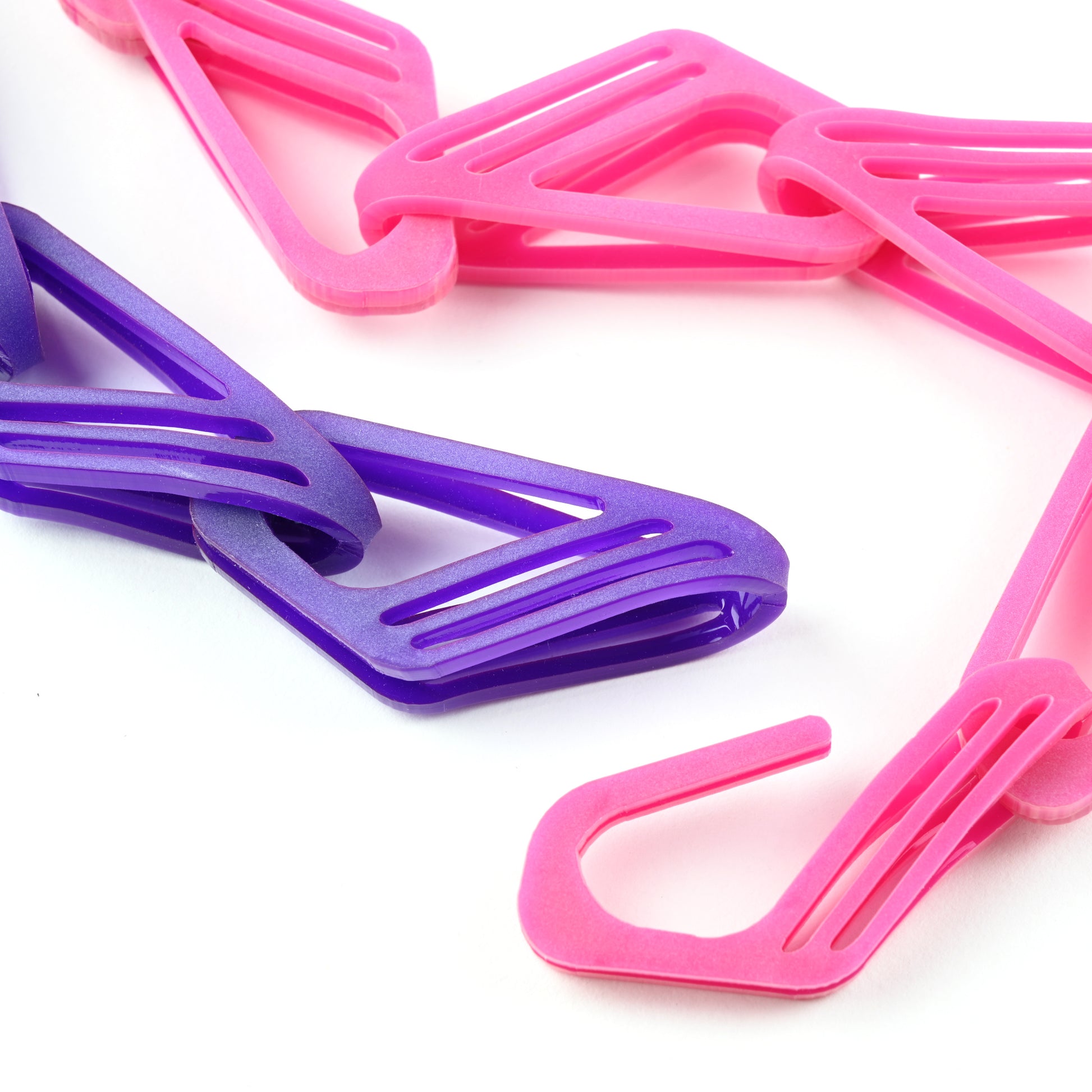 Necklace with pink and purple geometric links on a white background