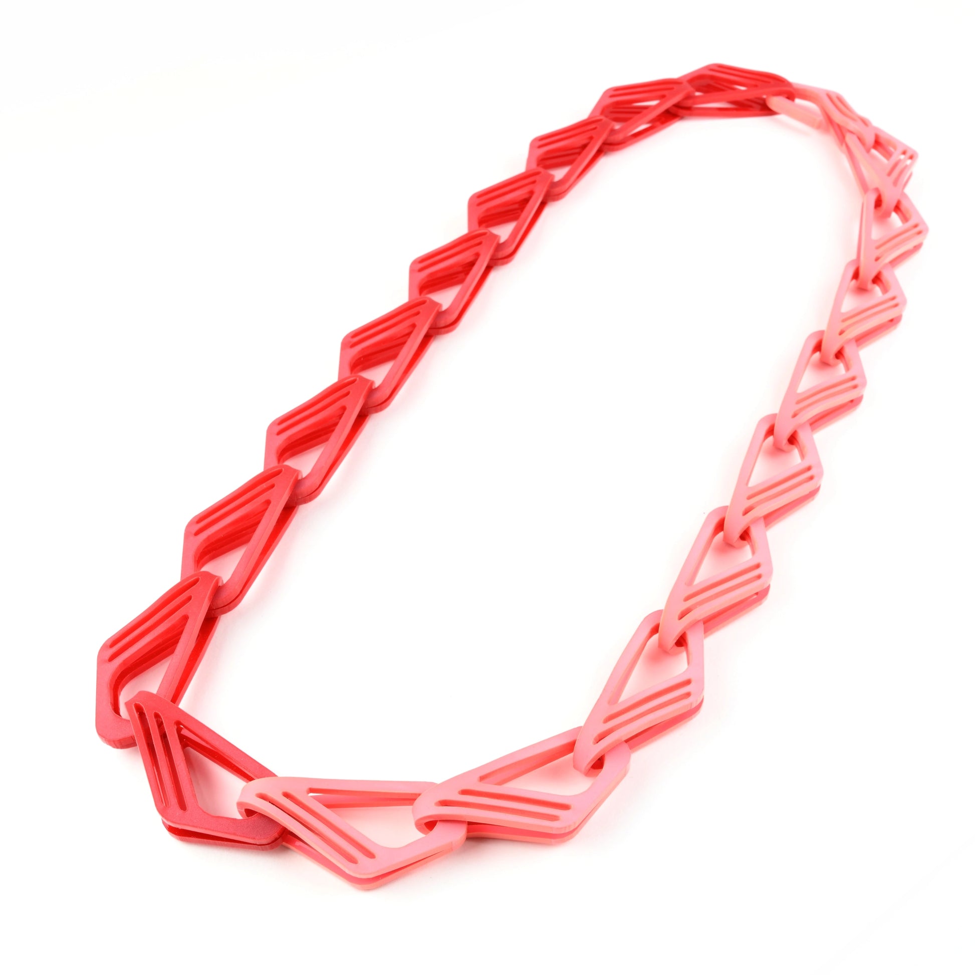 The Halite Acrylic Chain Necklace in Red & Pink with geometric links on a white background.