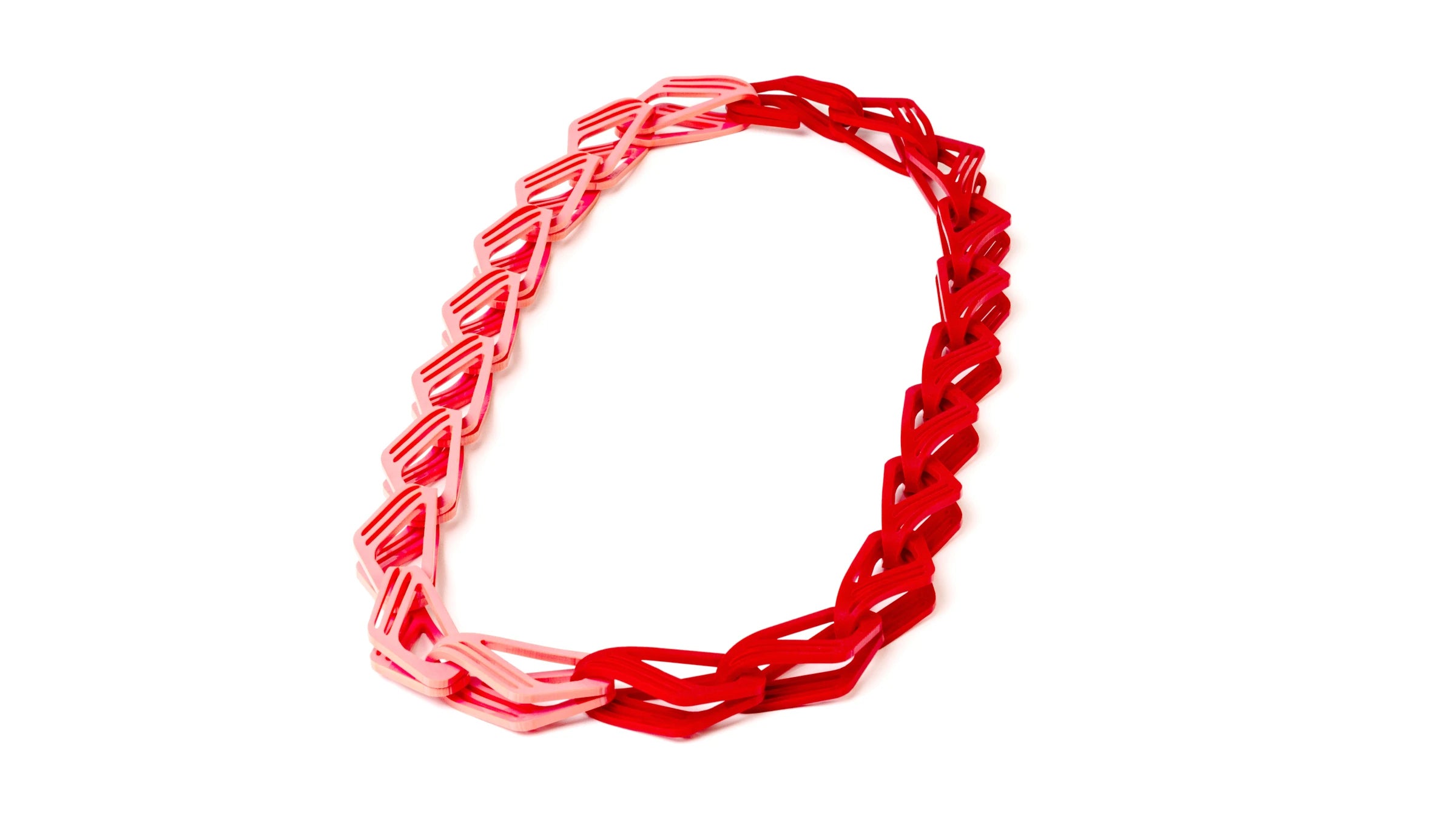 Bold statement red and pink acrylic chain on a white background.