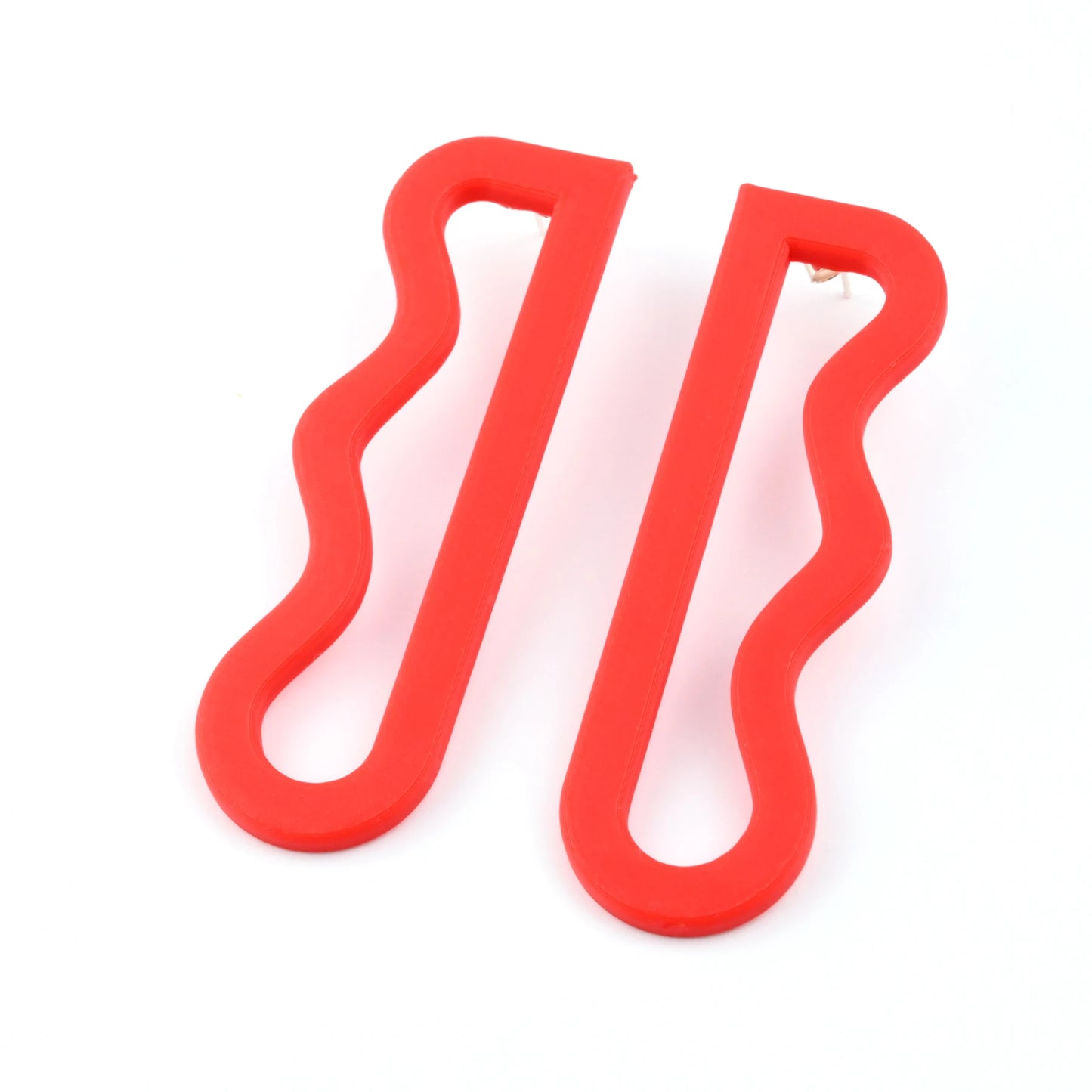 3D printed red wavy drop earrings by Roxwoods on a white background