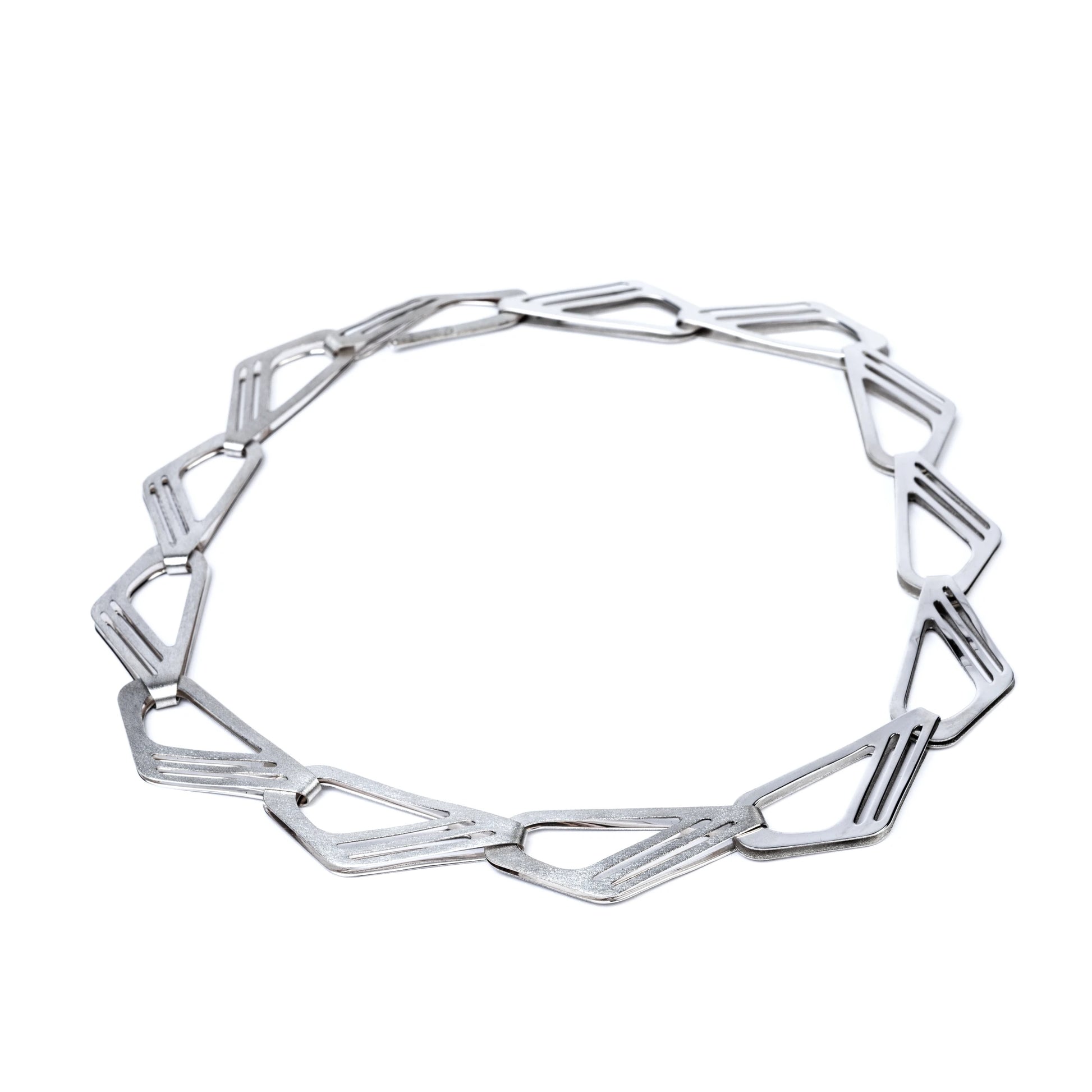 Silver geometric necklace on a white background