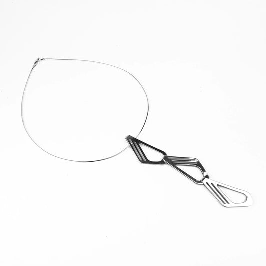 Silver necklace with 3 repeating links down hanging from the middle on a white background