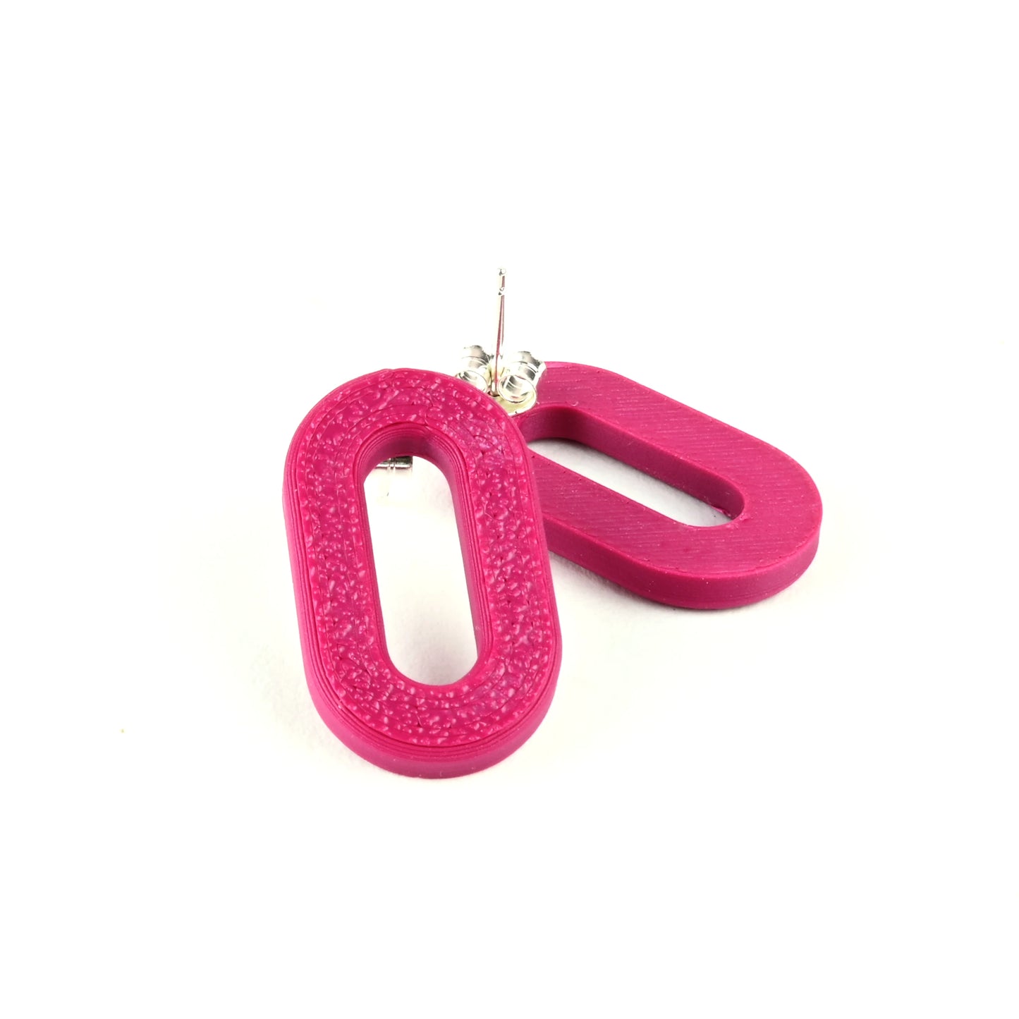 Plum oval earrings with a textured surface on a white background