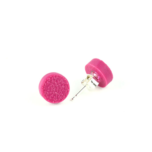 Tiny plum coloured stud earrings with textured surface on a white background.
