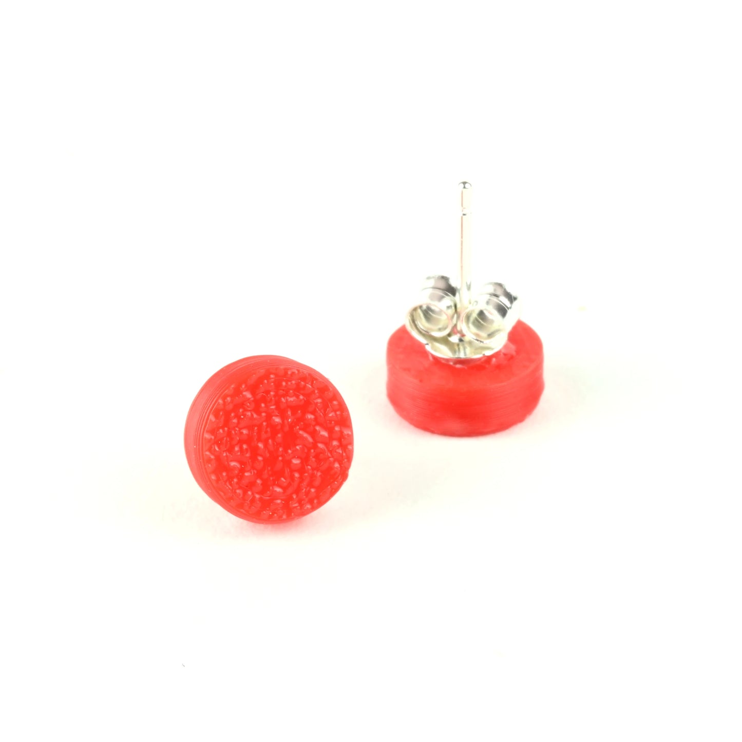 Red textured tiny round stud earrings on a white background