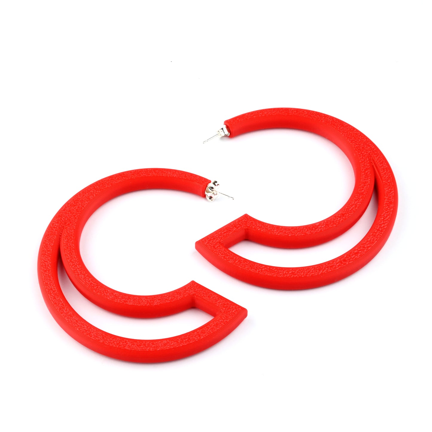 Red hoop earrings with large cut out section on a white background