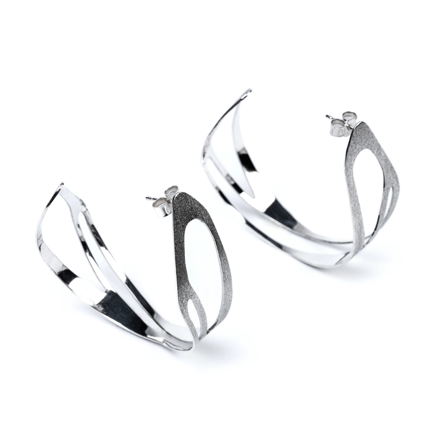Pair of silver hoop earrings with frosted texture on a white background