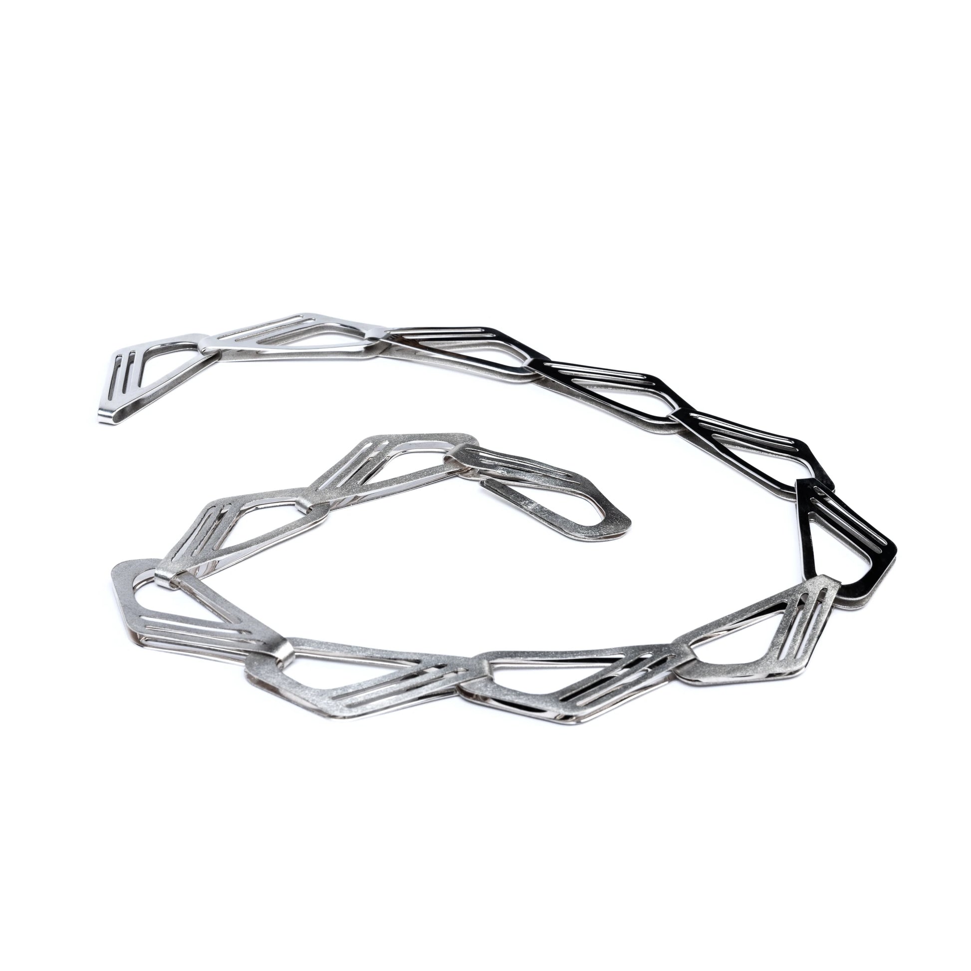Geometric silver necklace on a white background