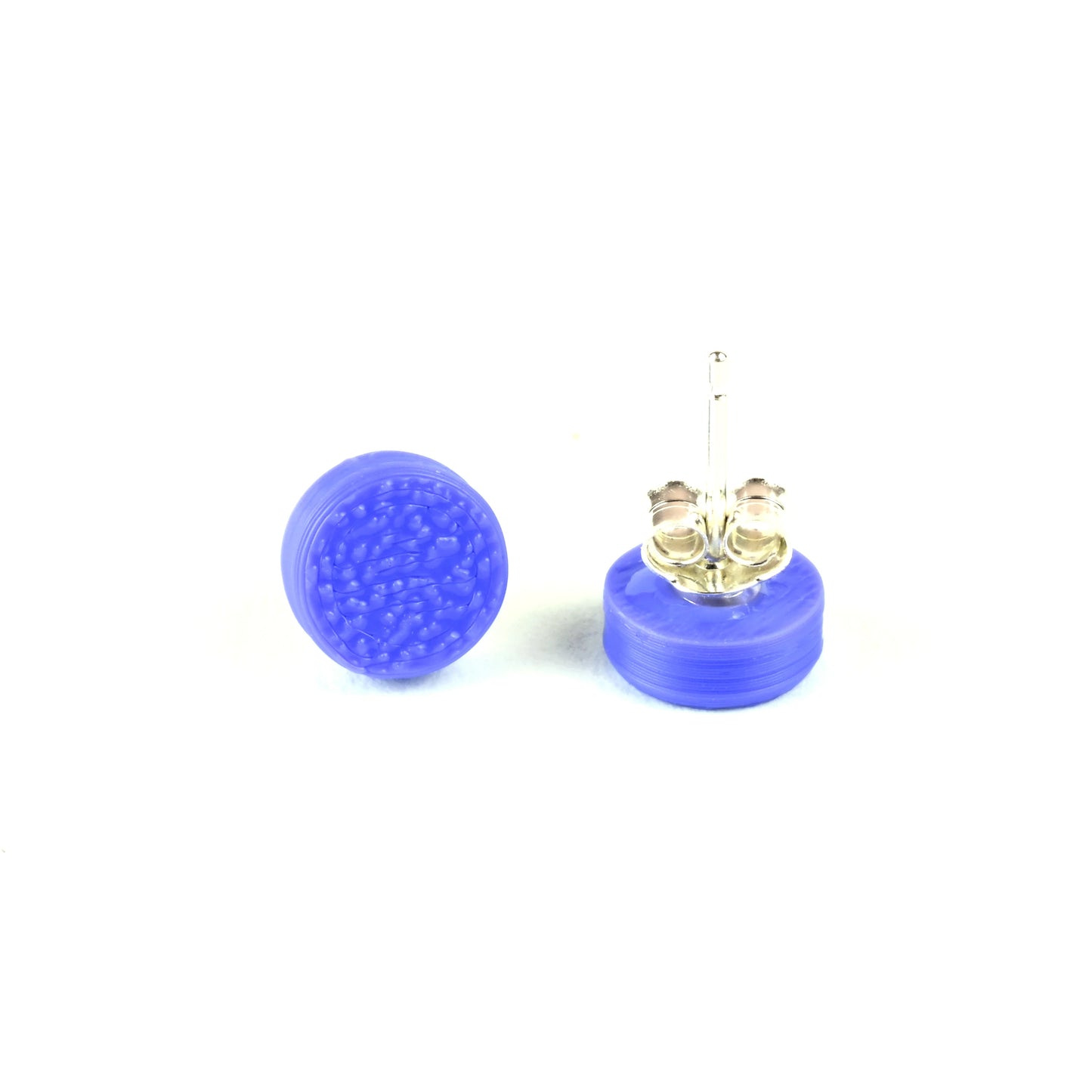 Pair of tiny purple textured stud earrings on a white background